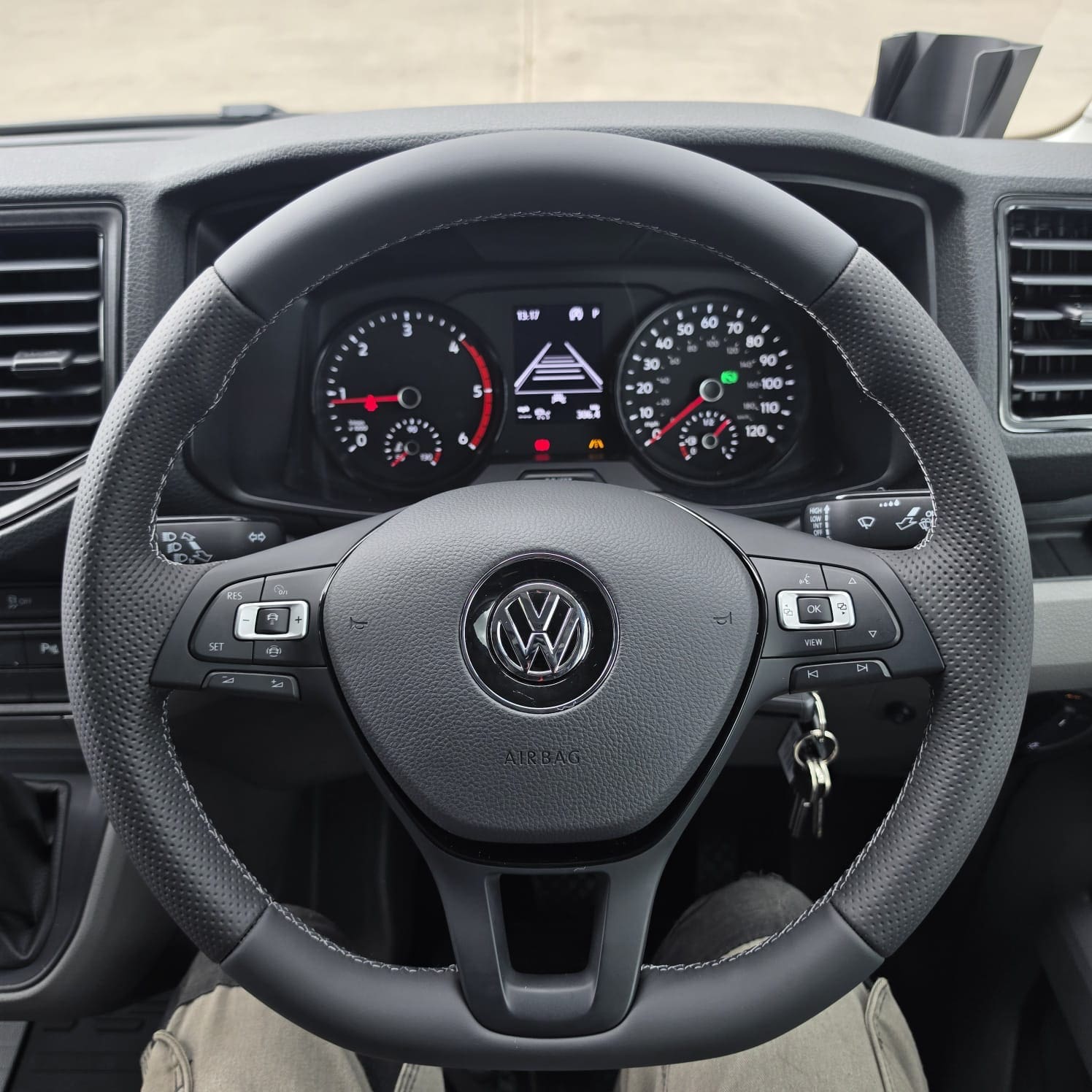 Silver VW Crafter interior with OEM flat bottom retrimmed steering wheel in Napa leather