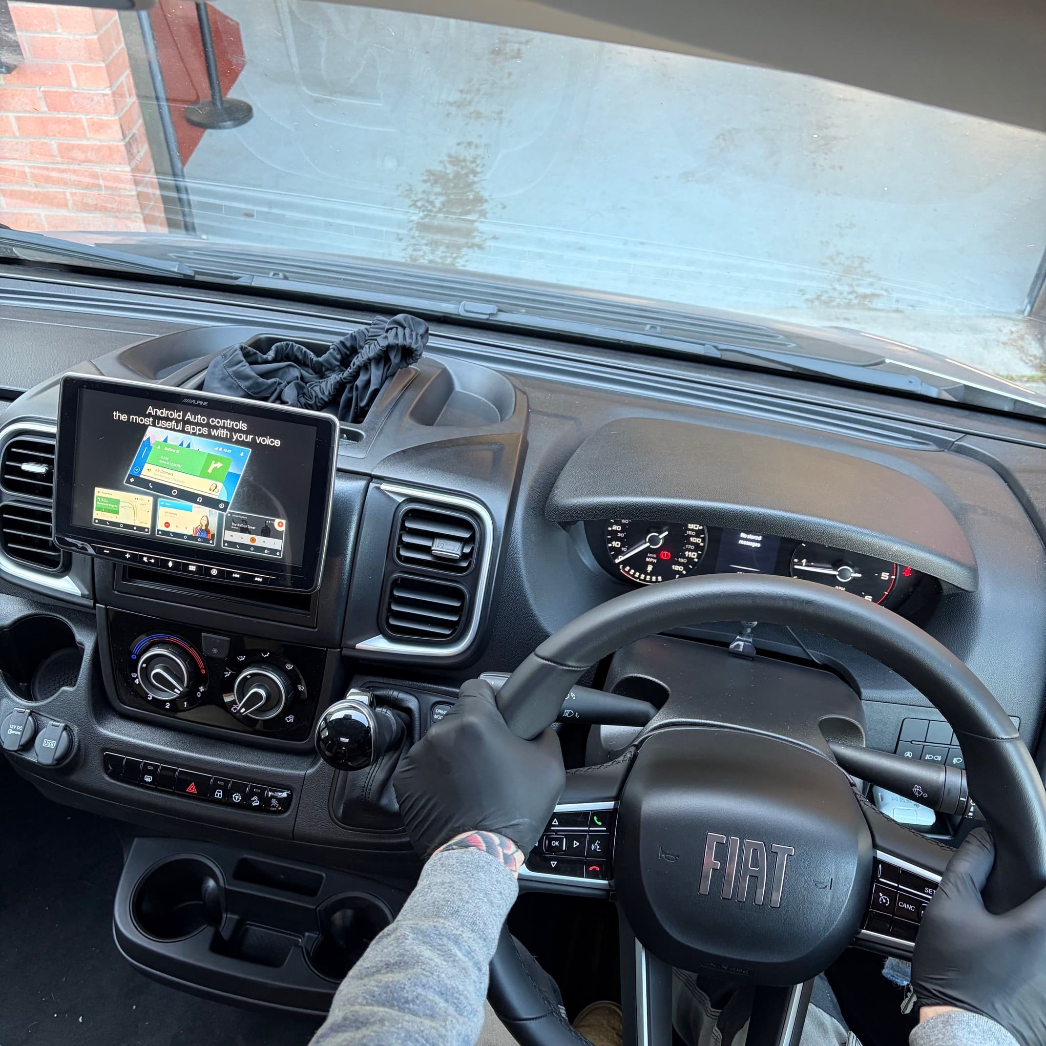Fiat Ducato dash area during Alpine Halo 9 installation with wiring checks in progress