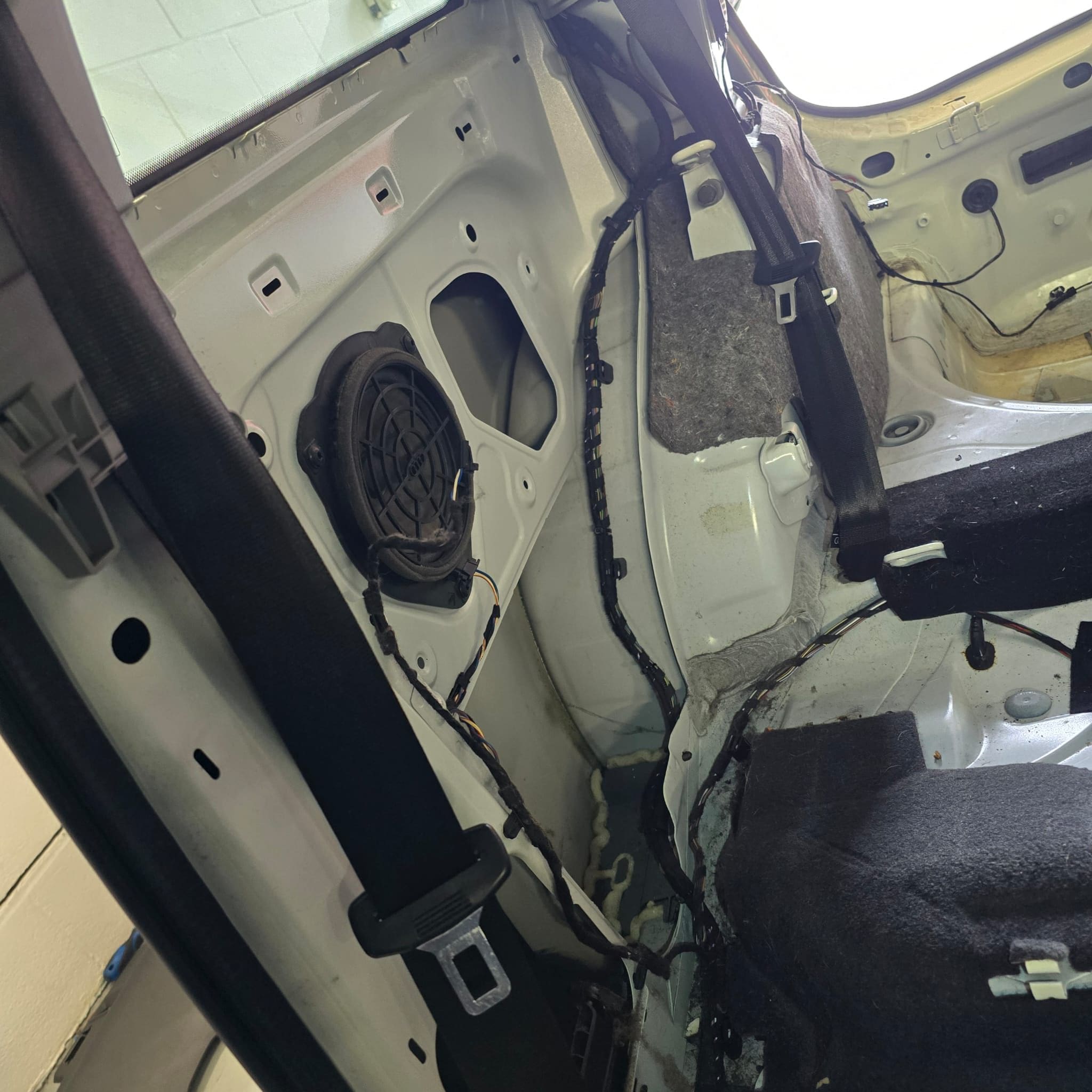 Audi A1 rear parking sensor retrofit showing bumper-off installation stage