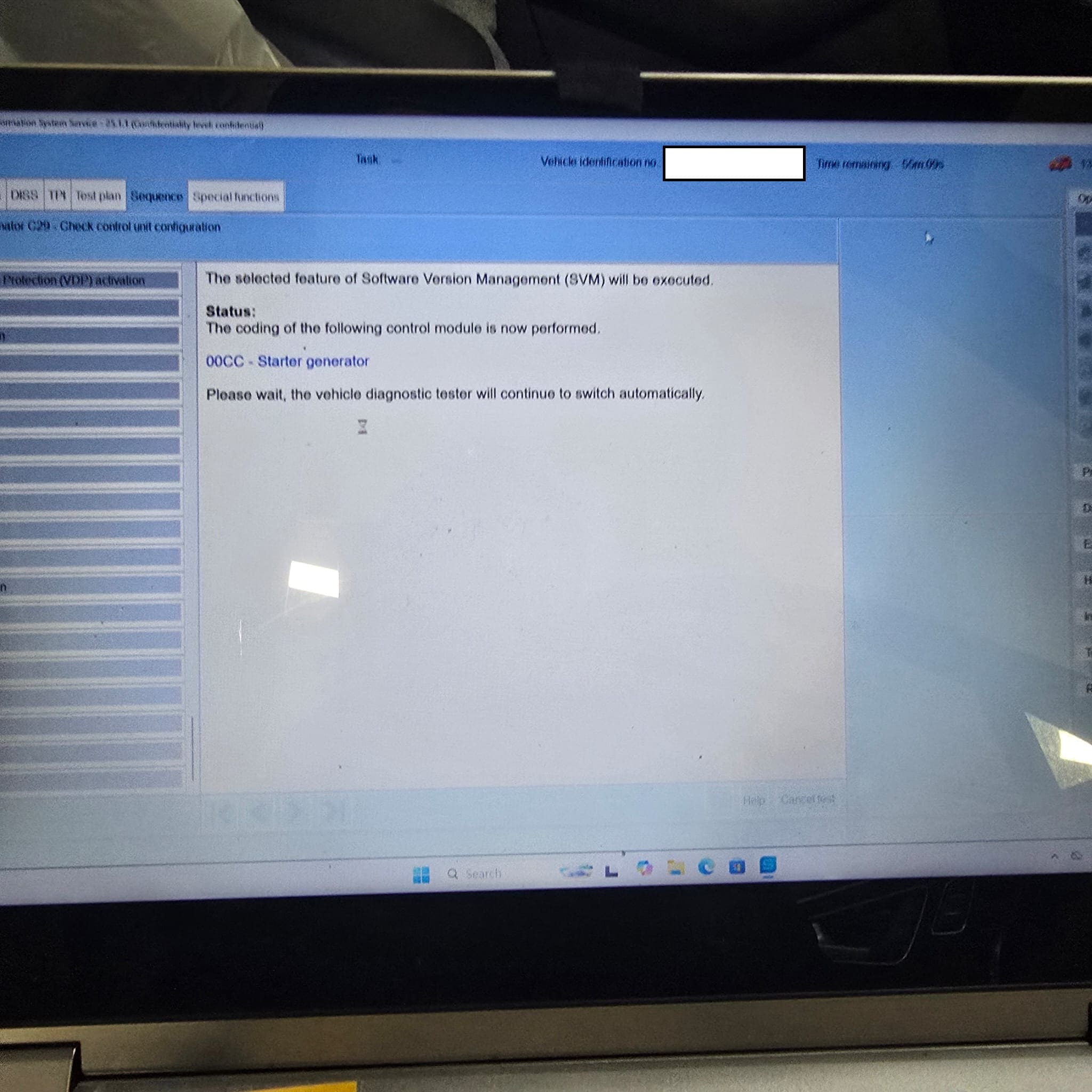 Diagnostic laptop connected to an Audi Q7 for 48V starter generator adaptation and setup