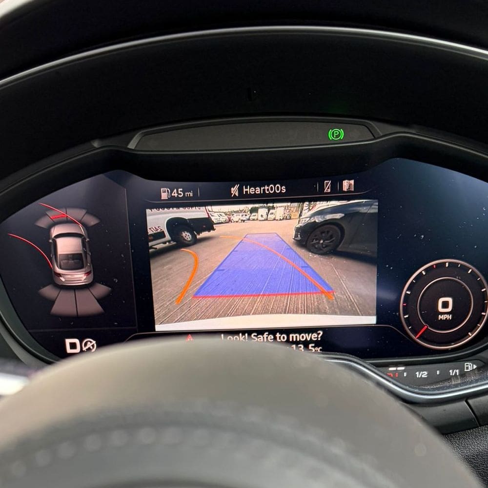 White Audi TT with TTS badge after Highline rear view camera retrofit completion