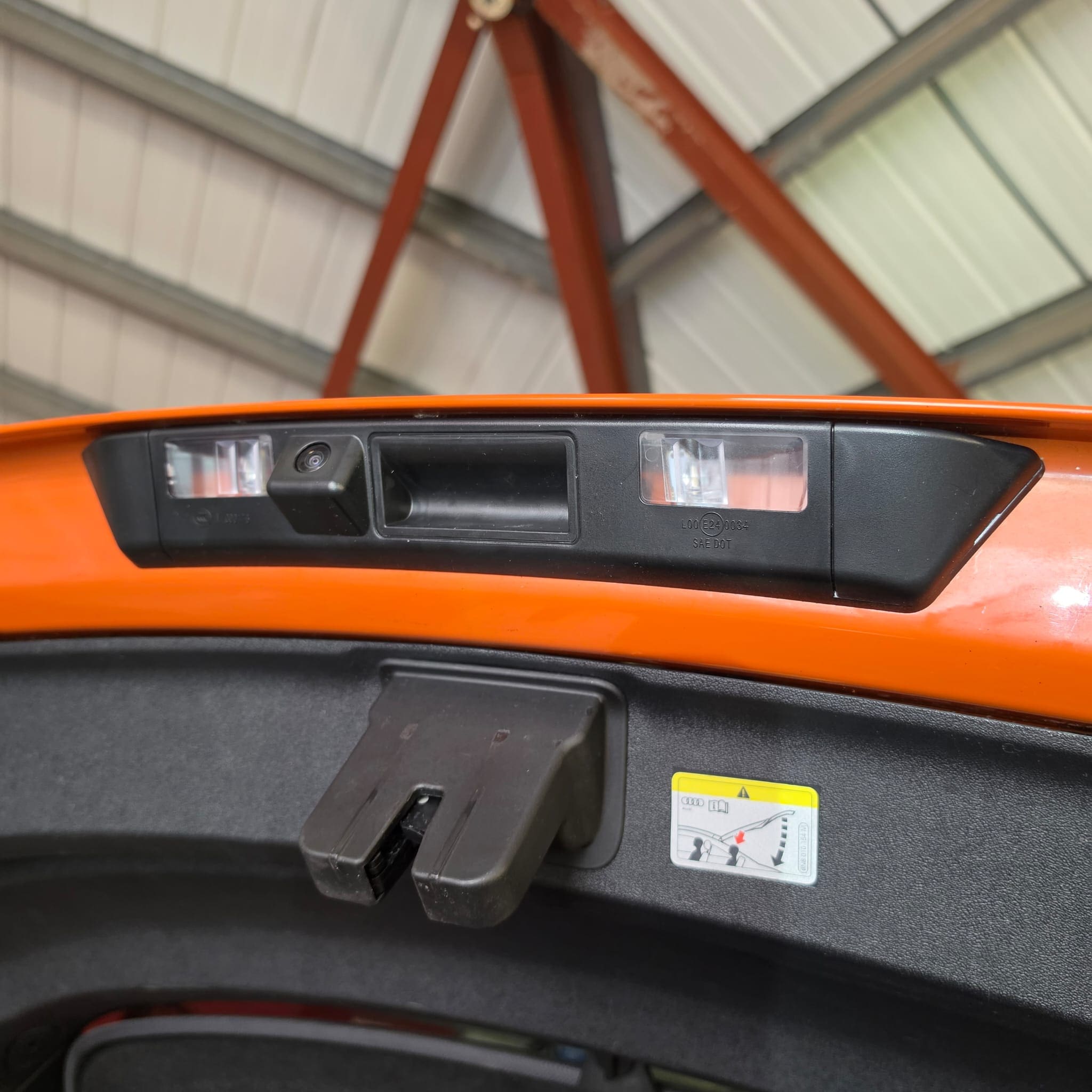 Rear view camera retrofit in progress on an Audi TTS Mk3 with trim removed