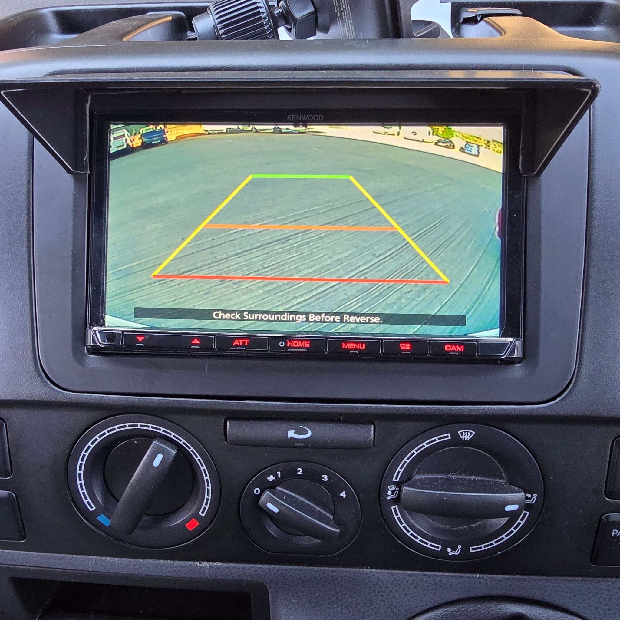 Rear view camera wiring being routed through a campervan pop top during retrofit work