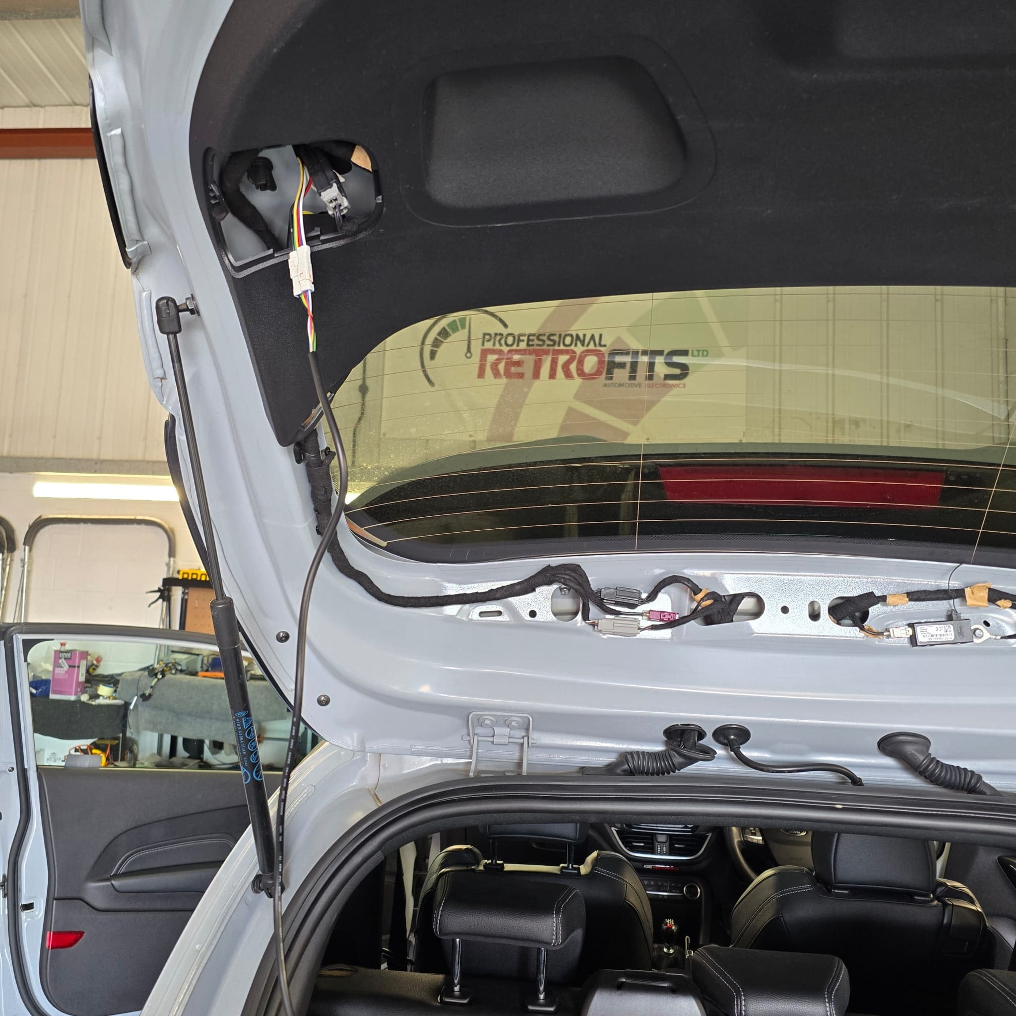 Finished Ford Fiesta ST tailgate light wiring retrofit with factory-style routing and secure fastening