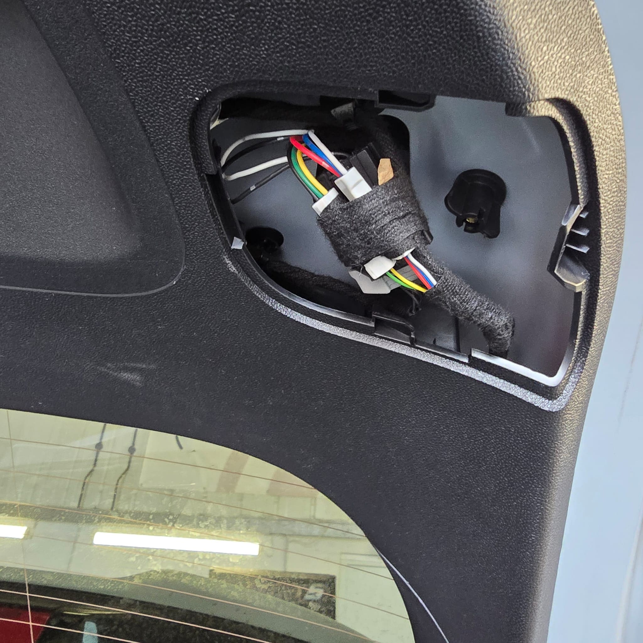 Ford Fiesta ST tailgate trim removed showing OEM-style cable routing for rear tailgate light wiring