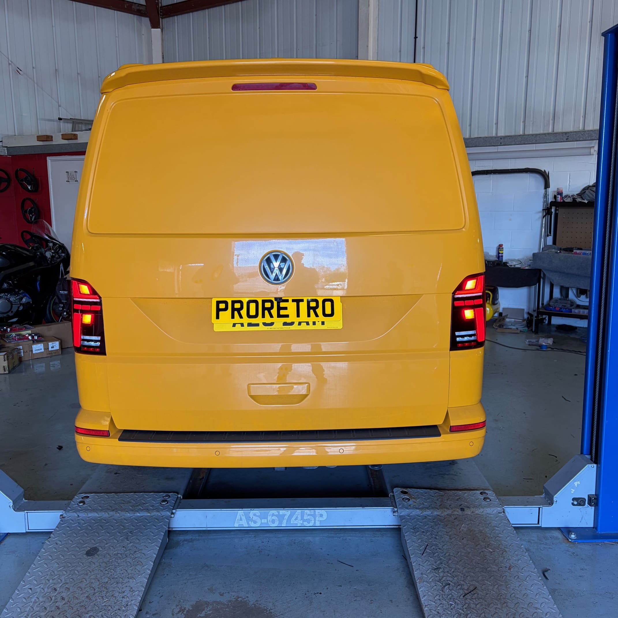 Rear view of a VW T6.1 showing genuine VW smoked LED taillights installed and ready for coding
