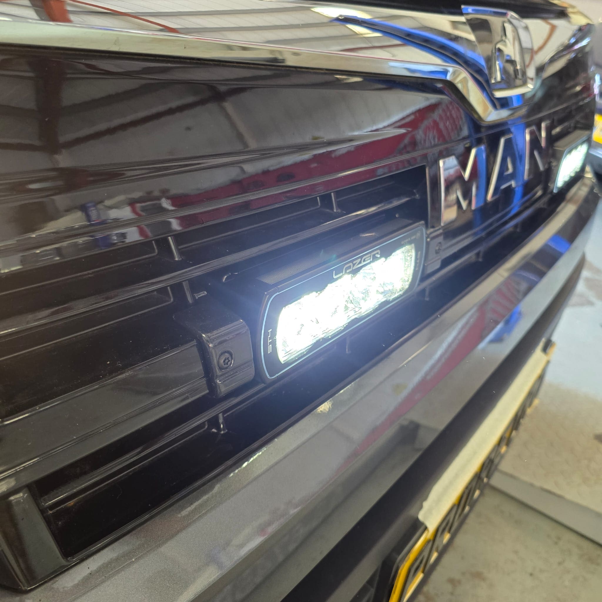 Front view of MAN TGE KNAUS with twin LAZER LED lights integrated into the grille