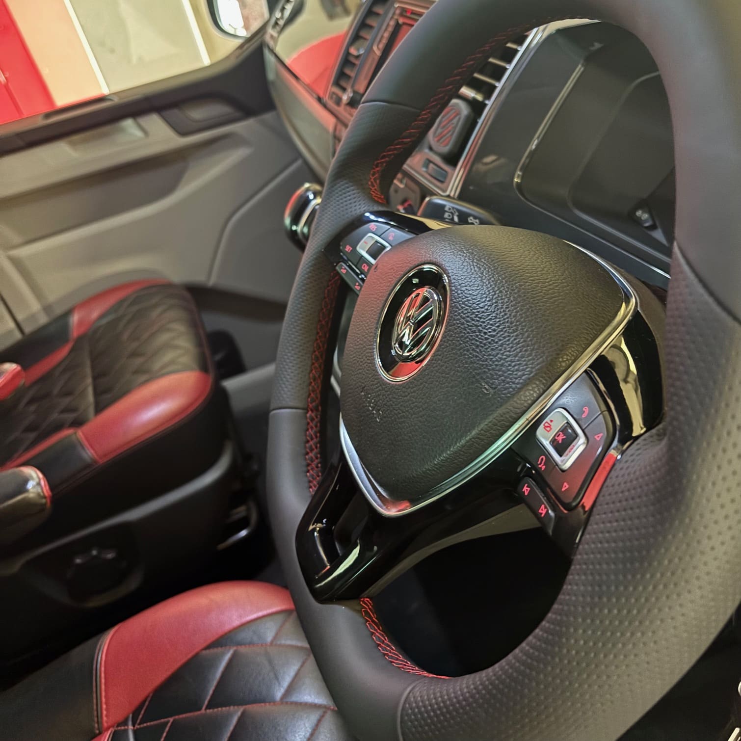 BadBoy steering wheel retrim detail showing leather texture changes and illuminated multifunction buttons