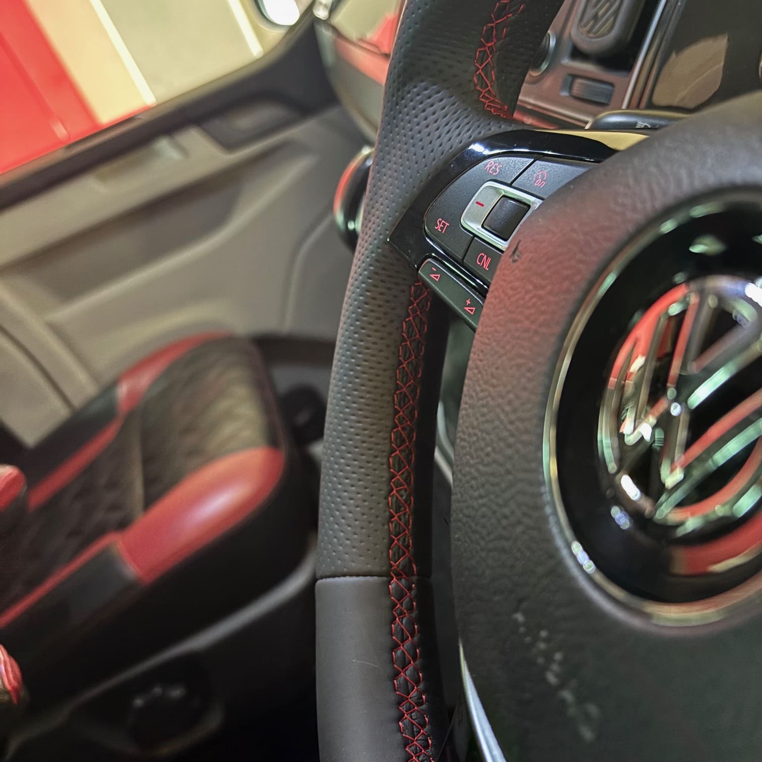 Finished mid-style BadBoy steering wheel showing matched red stitching and red button illumination