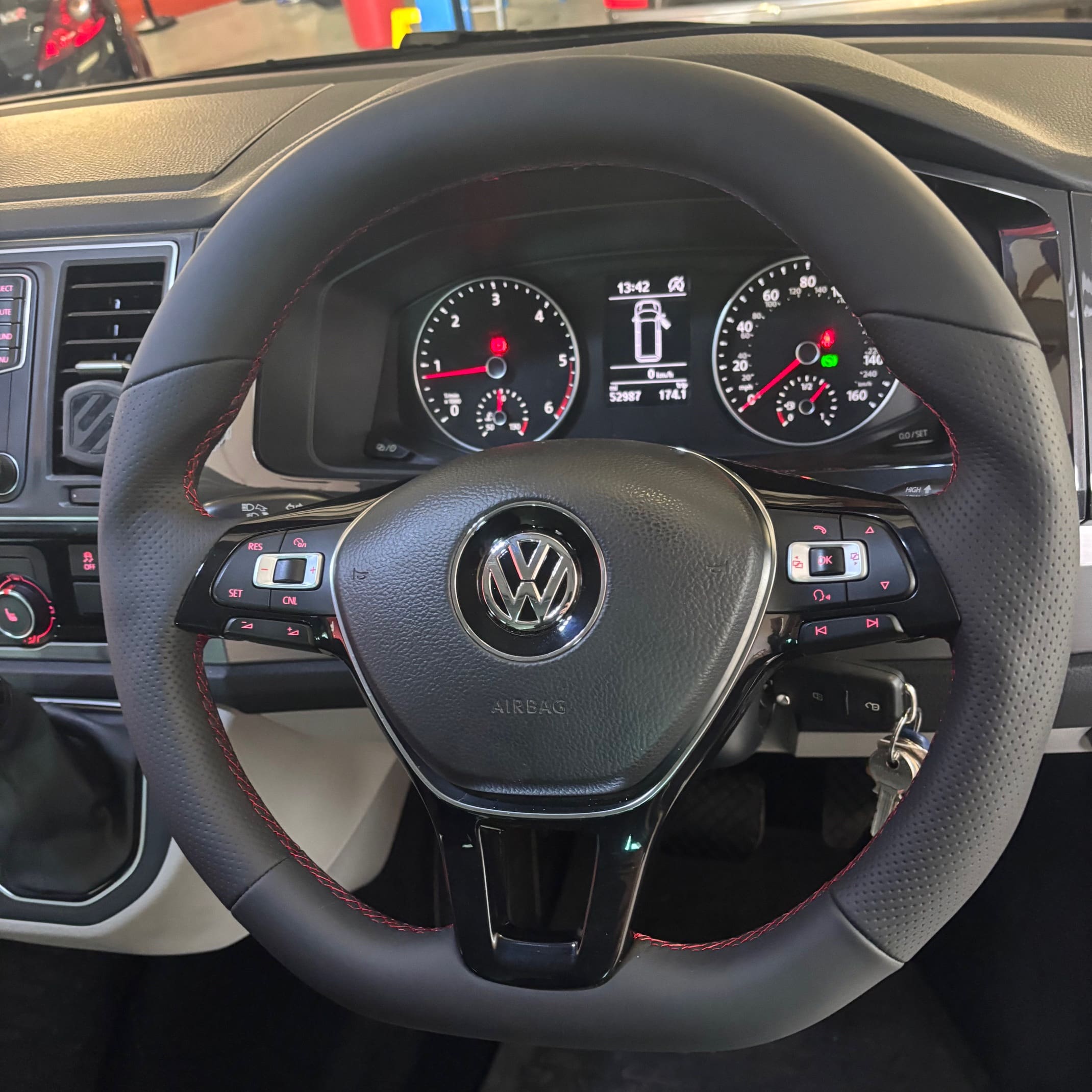Mid-style reshaped BadBoy steering wheel with red stitching and leather mix installed