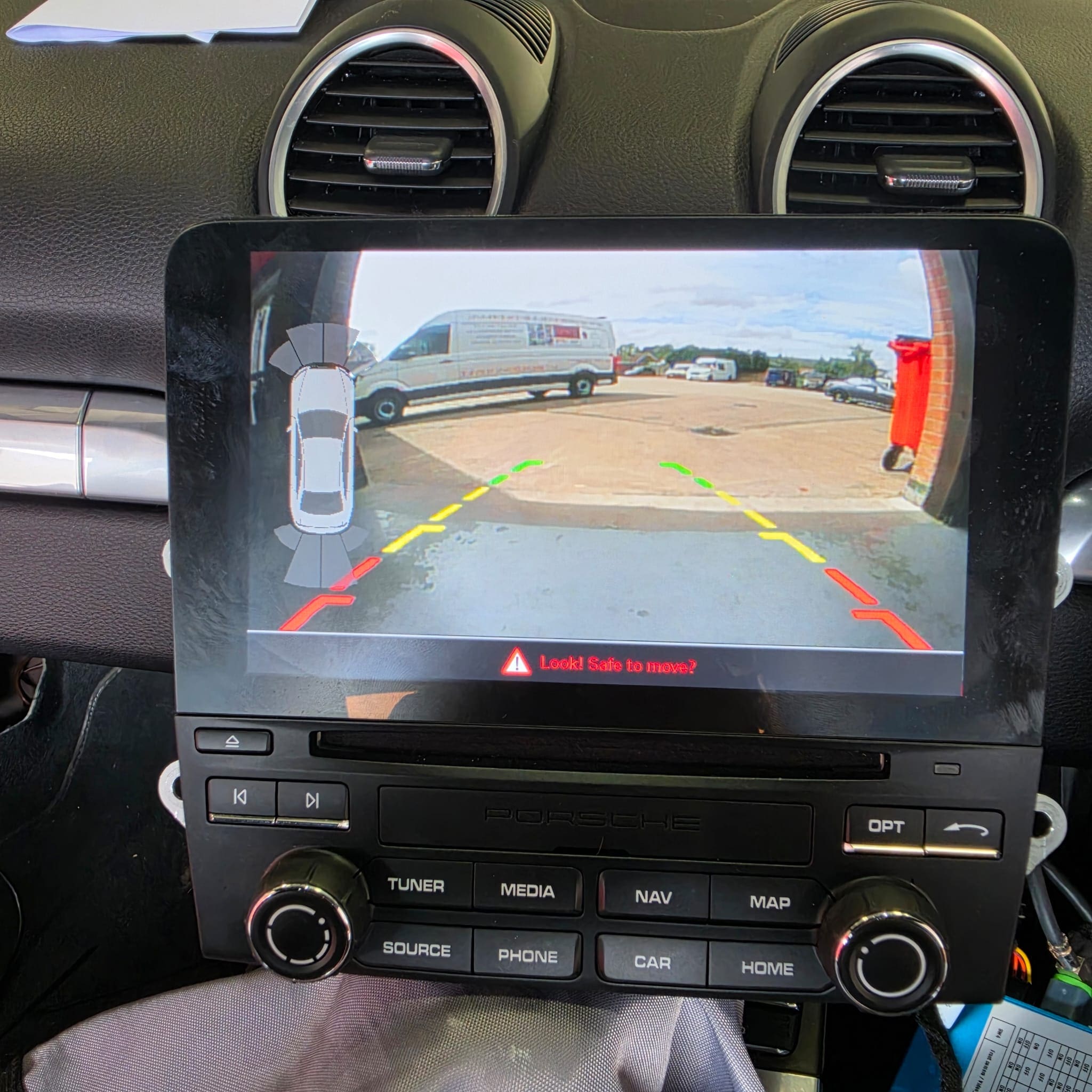 Porsche 718 Cayman rear view camera retrofit integrated with the OEM stereo