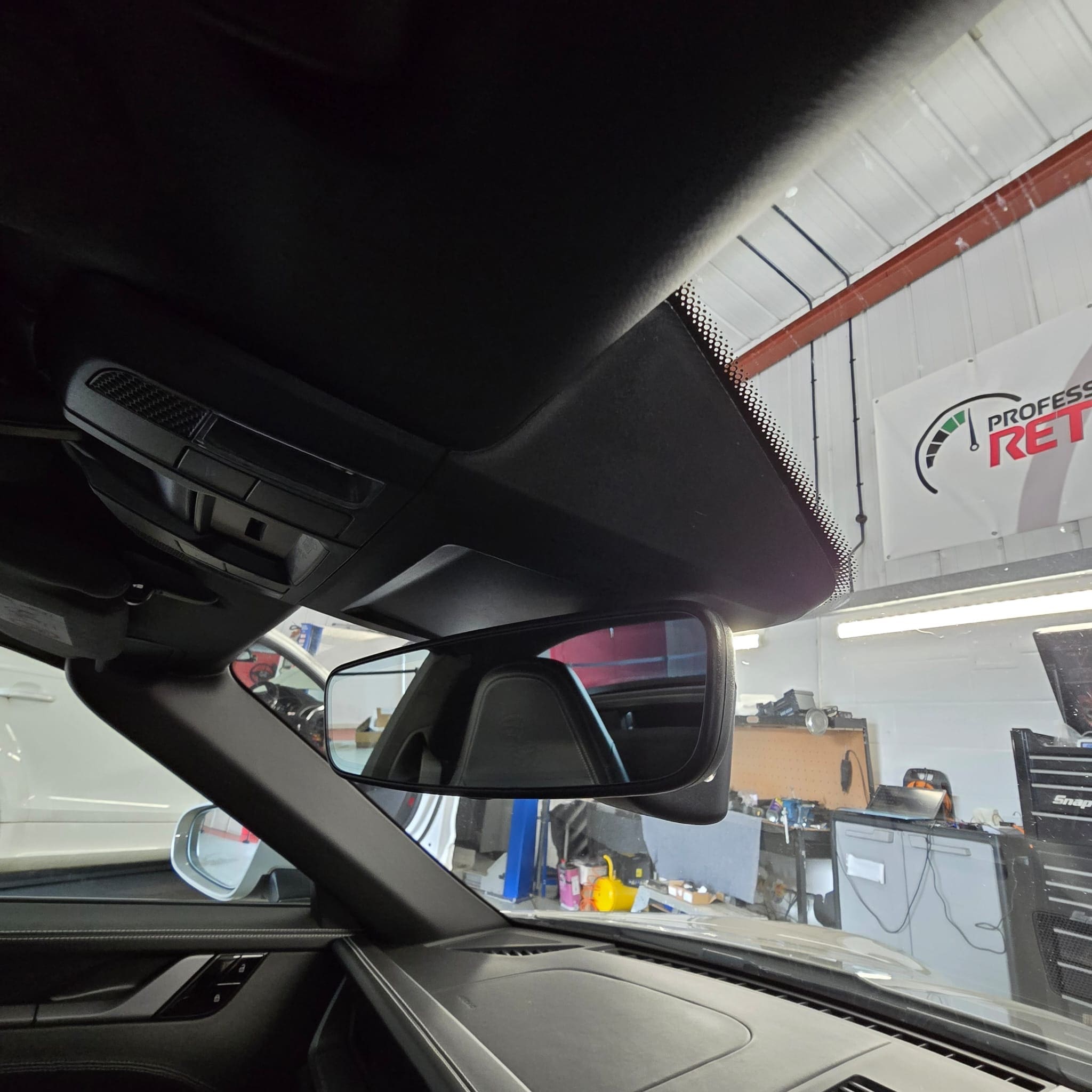 Driver perspective showing how the dash cam remains discreet when integrated into the Porsche 911 mirror trim