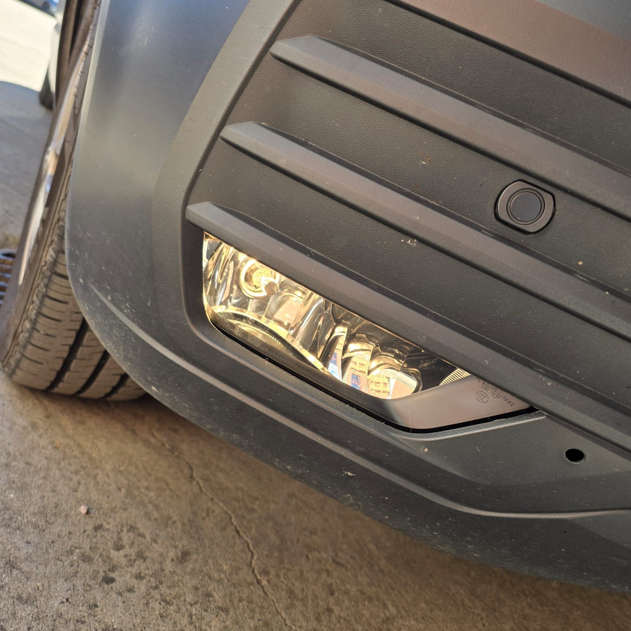 Front fog light retrofit components prepared for OEM-style installation on a VW T6.1