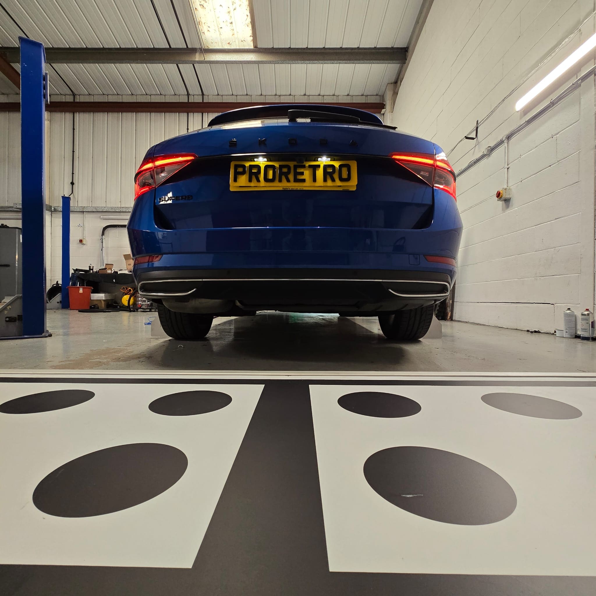 OEM-style wiring routing along factory looms for a Skoda Superb reversing camera retrofit