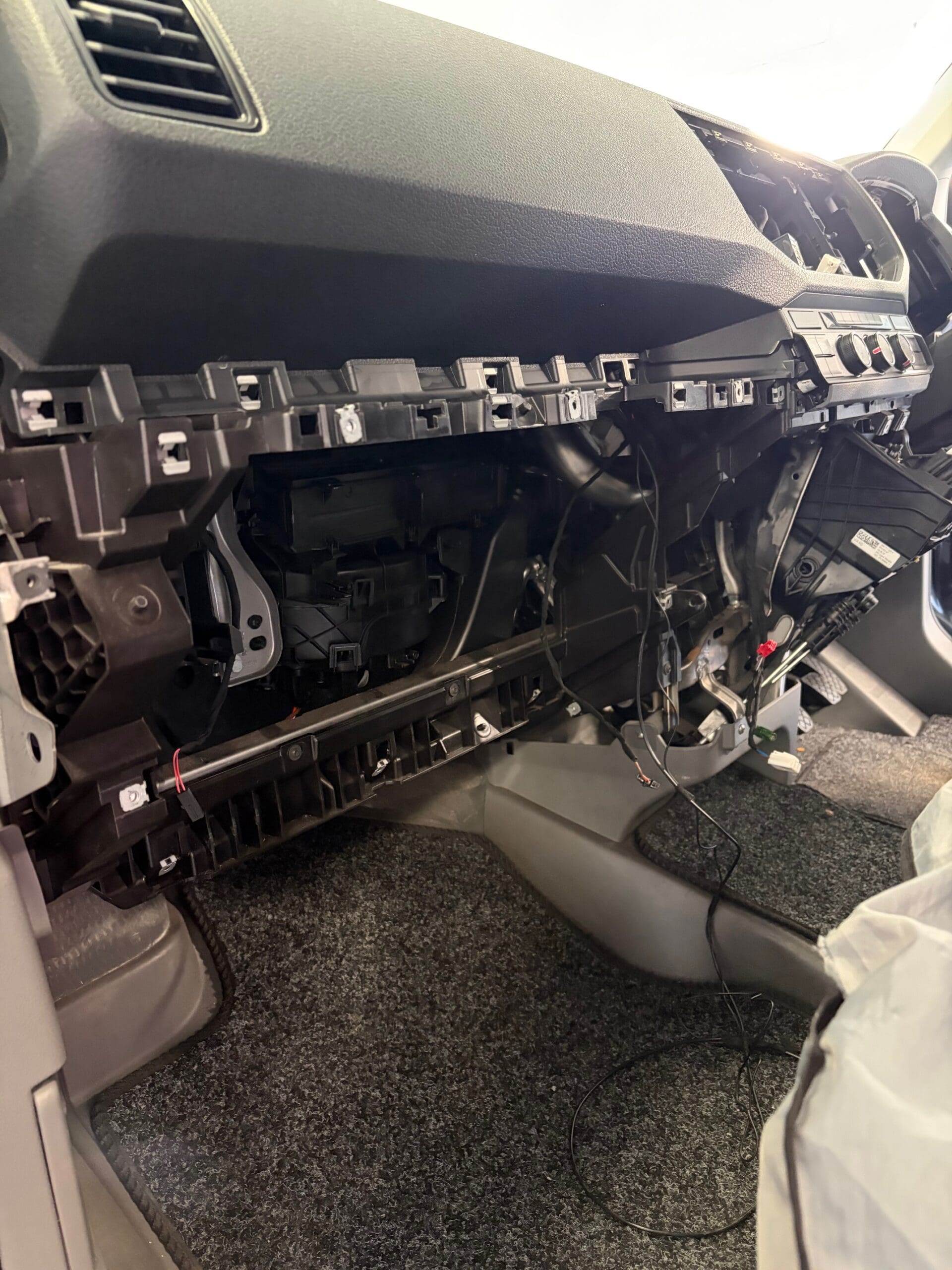 VW Crafter dashboard stripped during Alpine Halo 9 head unit installation with wiring harness visible mid-install