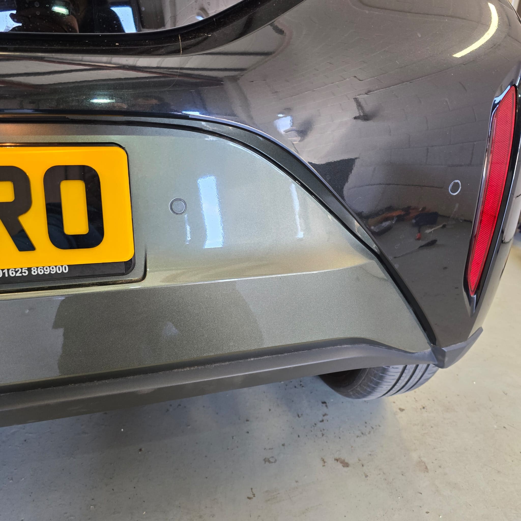Rear bumper view of Toyota Aygo X Edge after Vodafone parking sensor retrofit with neat alignment