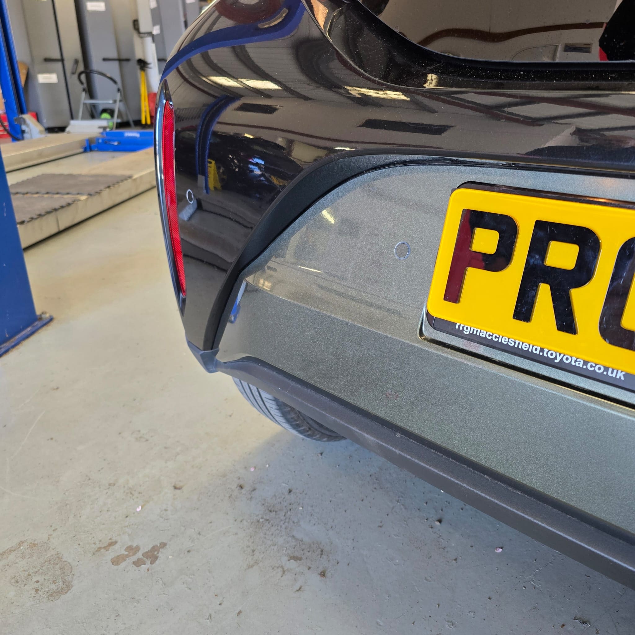 Rear parking sensor retrofit on a Toyota Aygo X Edge showing a clean, flush-fit sensor position in the bumper