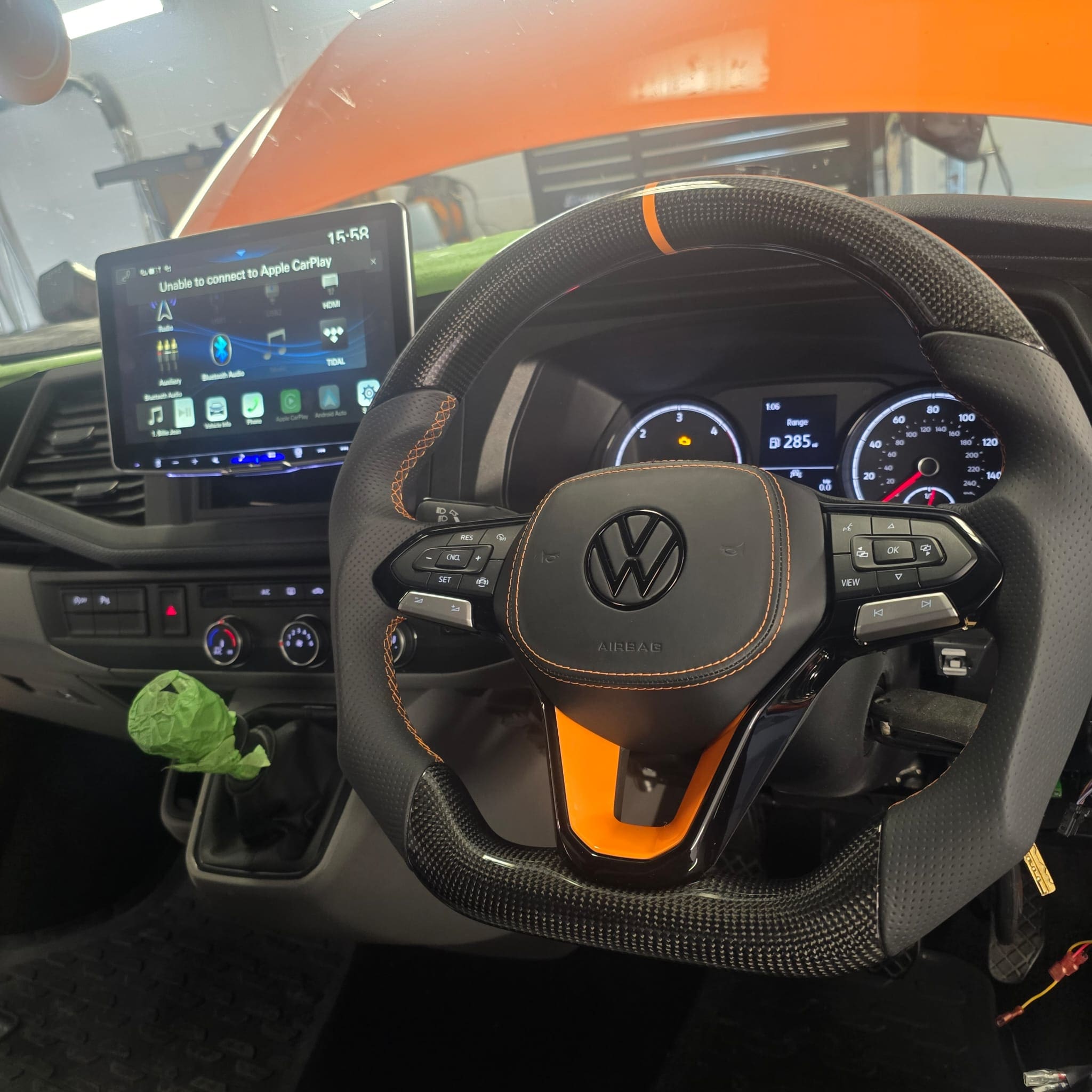 Finished interior view showing the carbon fibre steering wheel and airbag cover overlay installed