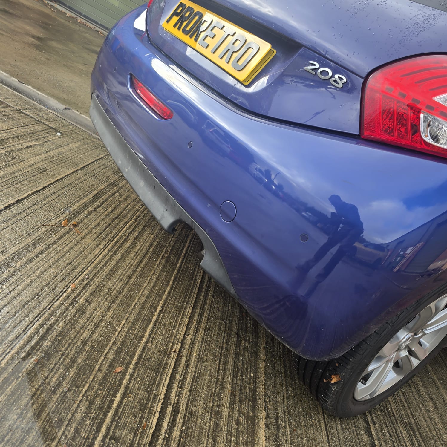 Rear parking sensor wiring routed inside Peugeot 208 bumper