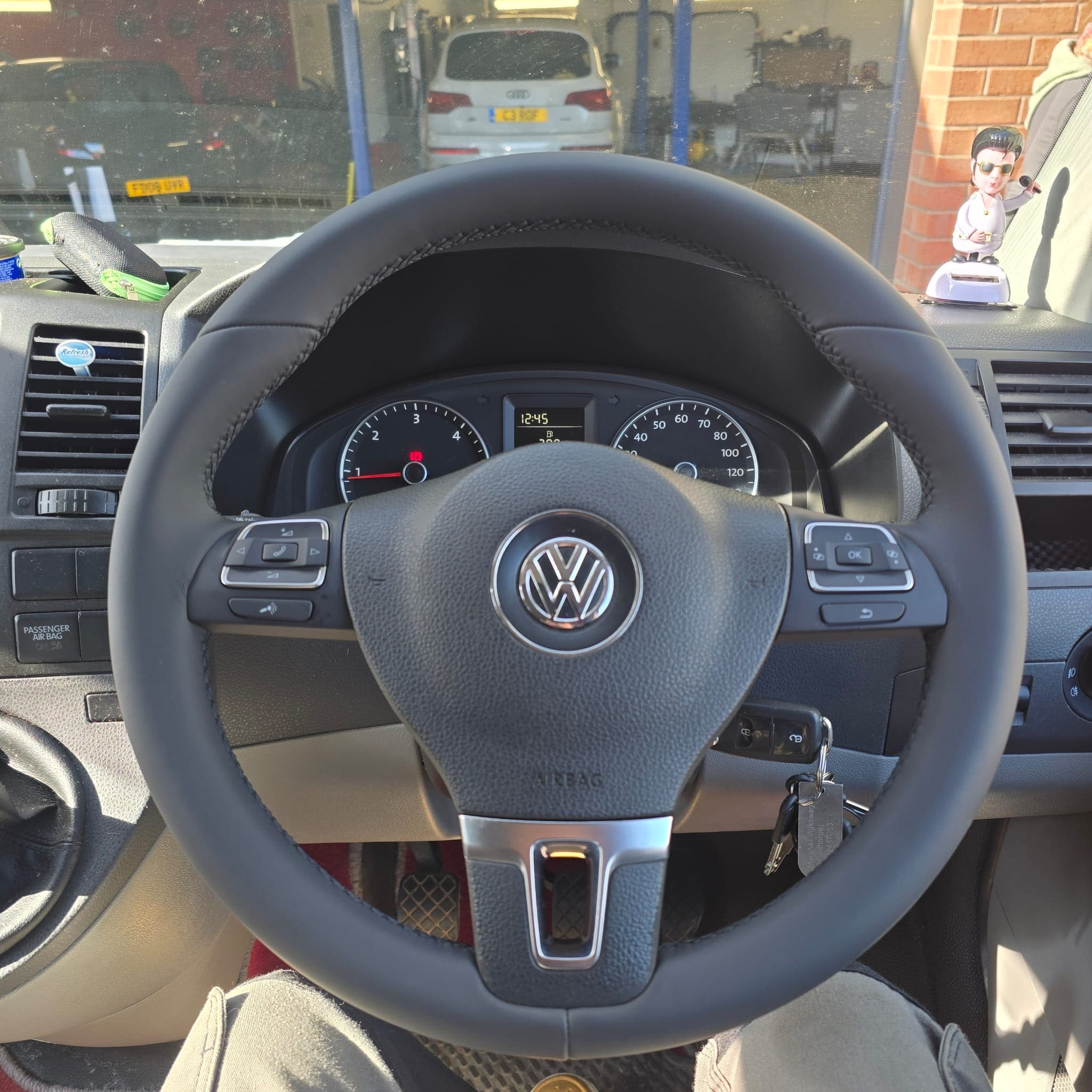 Custom round multifunction steering wheel fitted in a VW T5.1 with premium trim detail