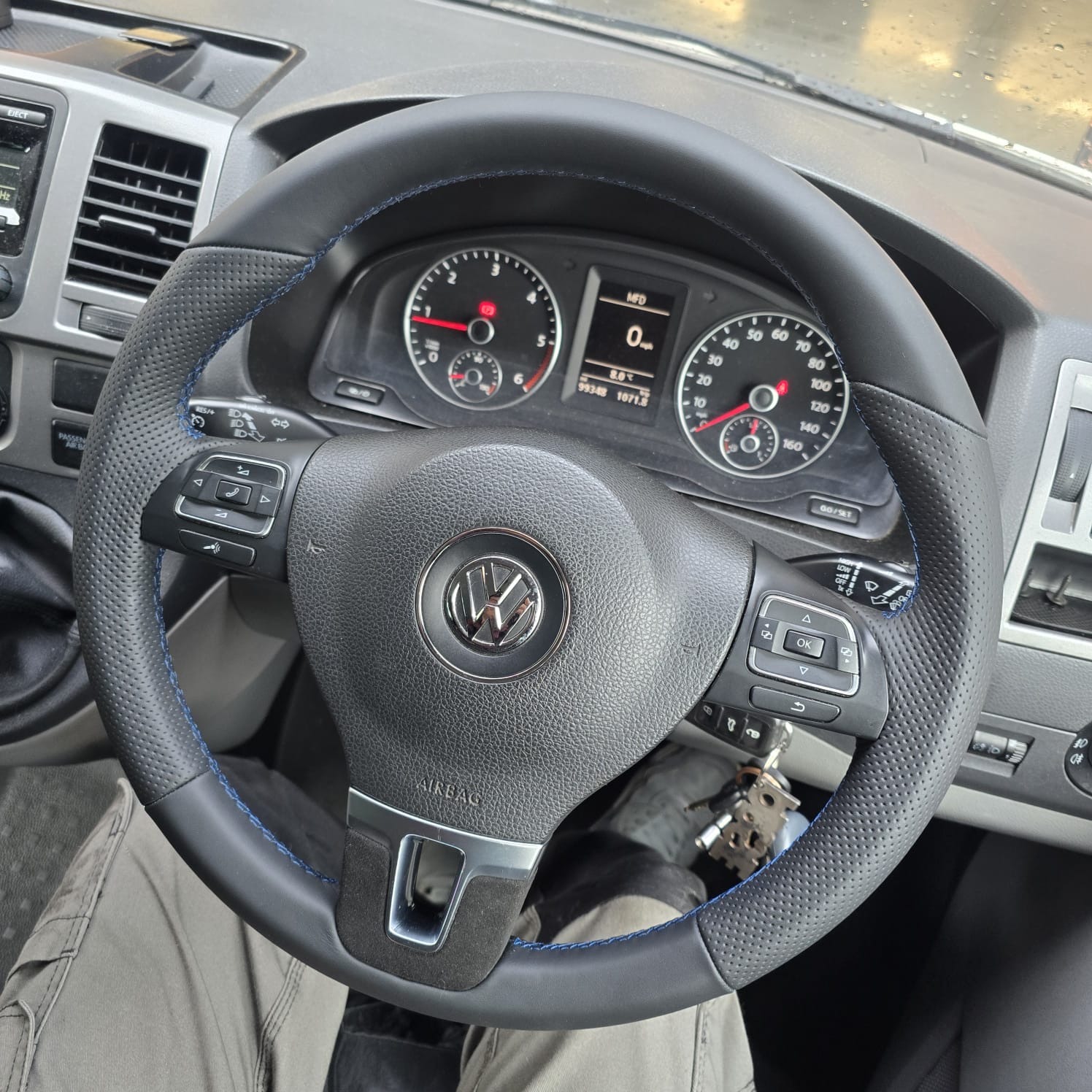 Steering wheel retrimmed with blue stitching and OEM feel