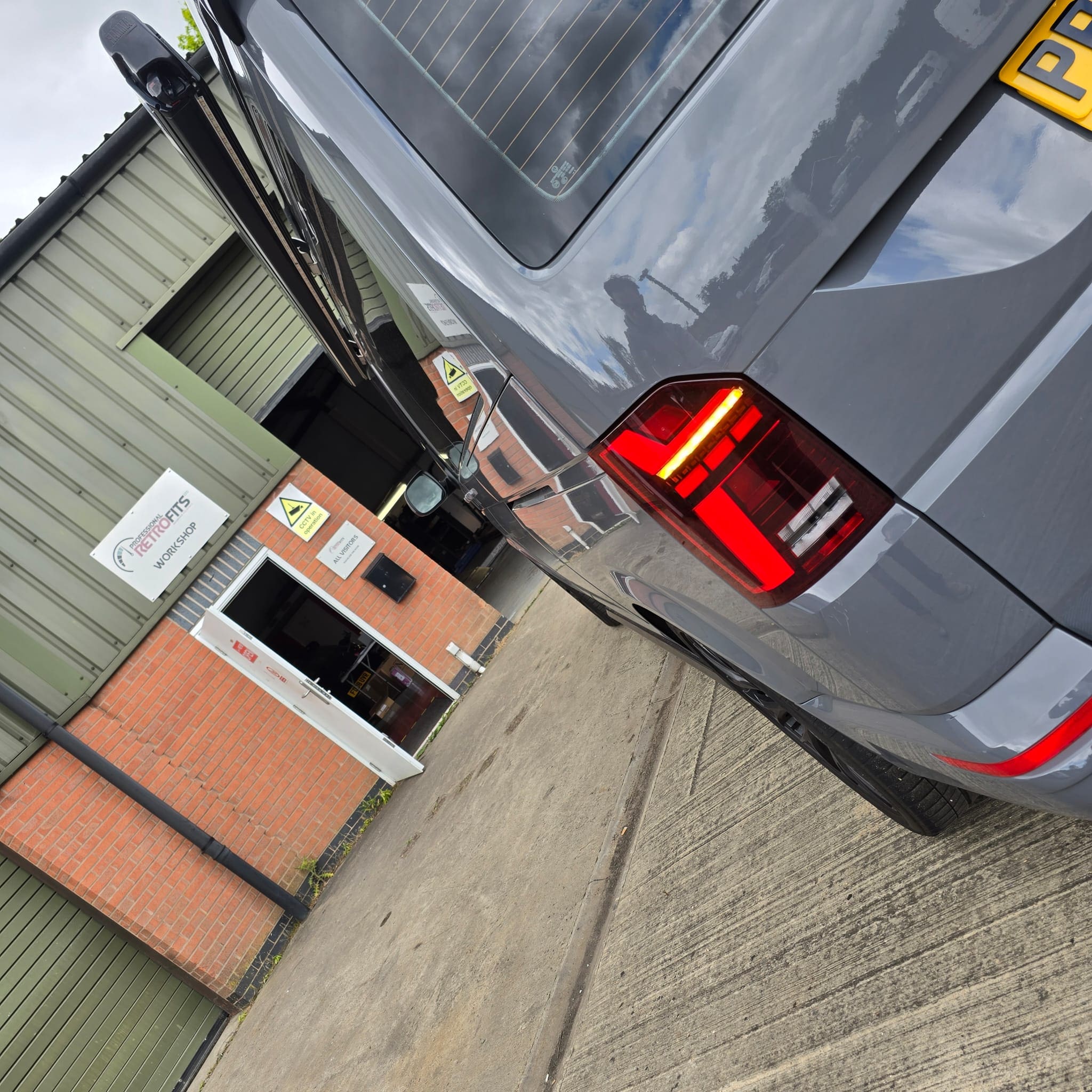 Rear view detail after OEM smoked LED tail light retrofit on VW T6.1