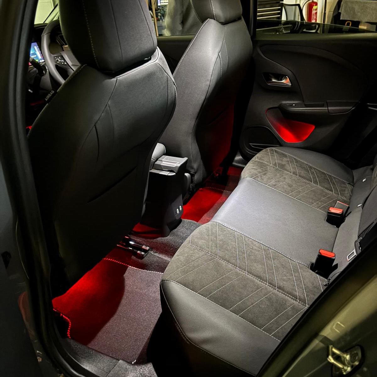 Red footwell ambient lighting in a Vauxhall Astra after retrofit installation