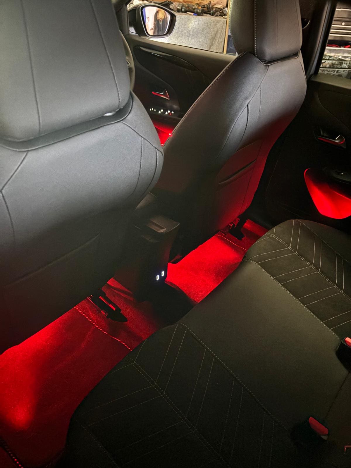 Red ambient lighting across Vauxhall Astra door cards and footwells after full-day install