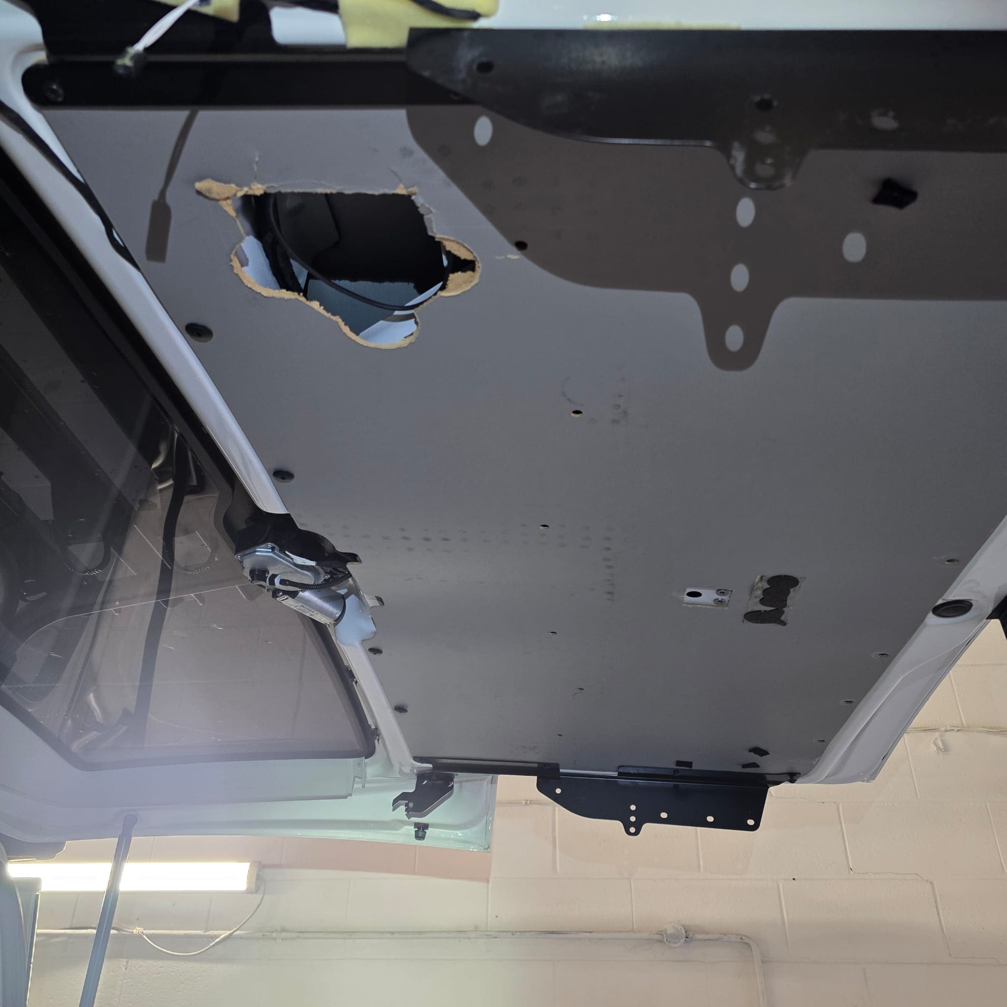 Tailgate panel area repaired and wiring accessed neatly without cutting new holes on Volkswagen California