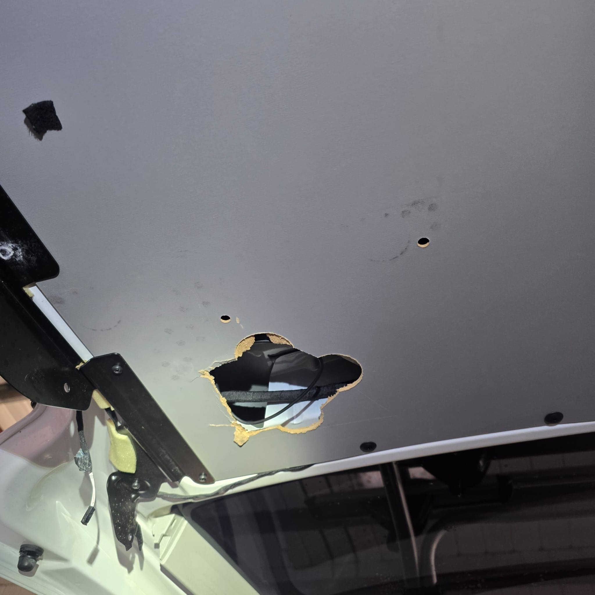 Rear view camera wiring access corrected after previous WOLFBOX install damage on Volkswagen California