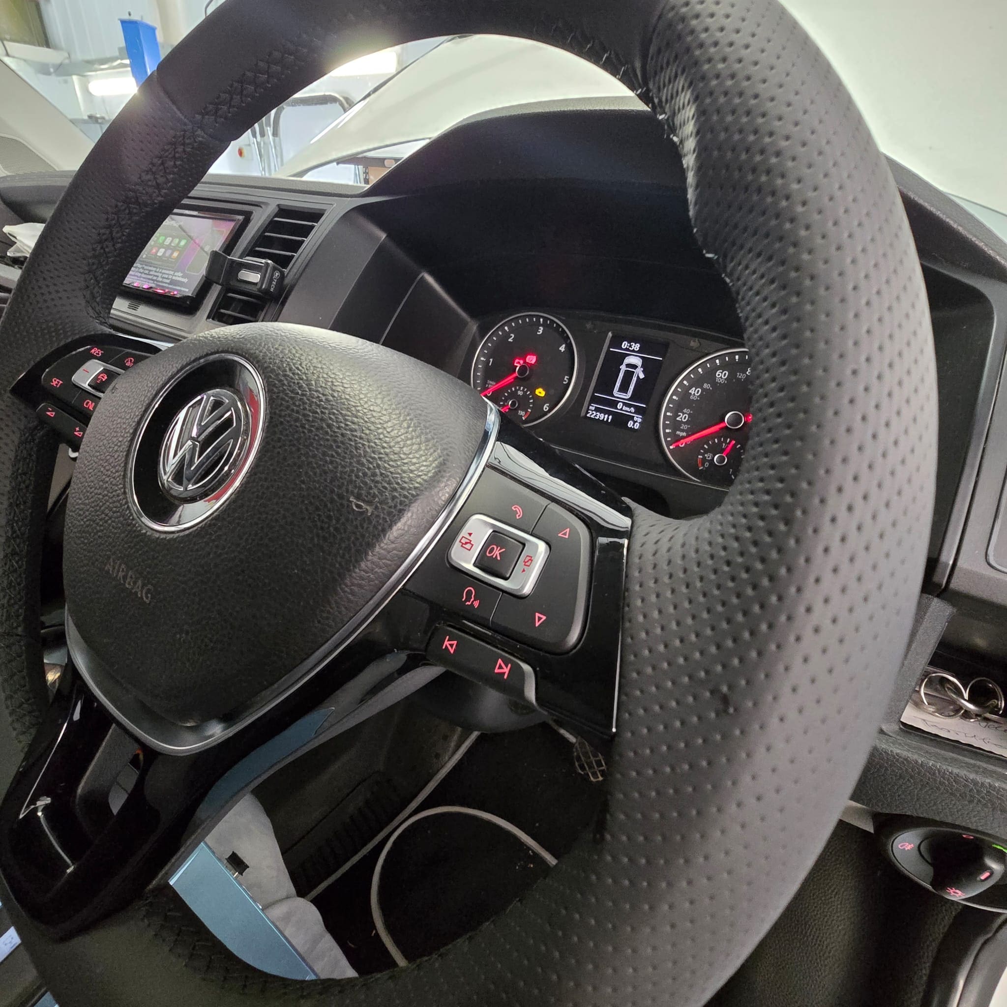 Detailed view of black stitching on a hand-trimmed Volkswagen Transporter T6 steering wheel