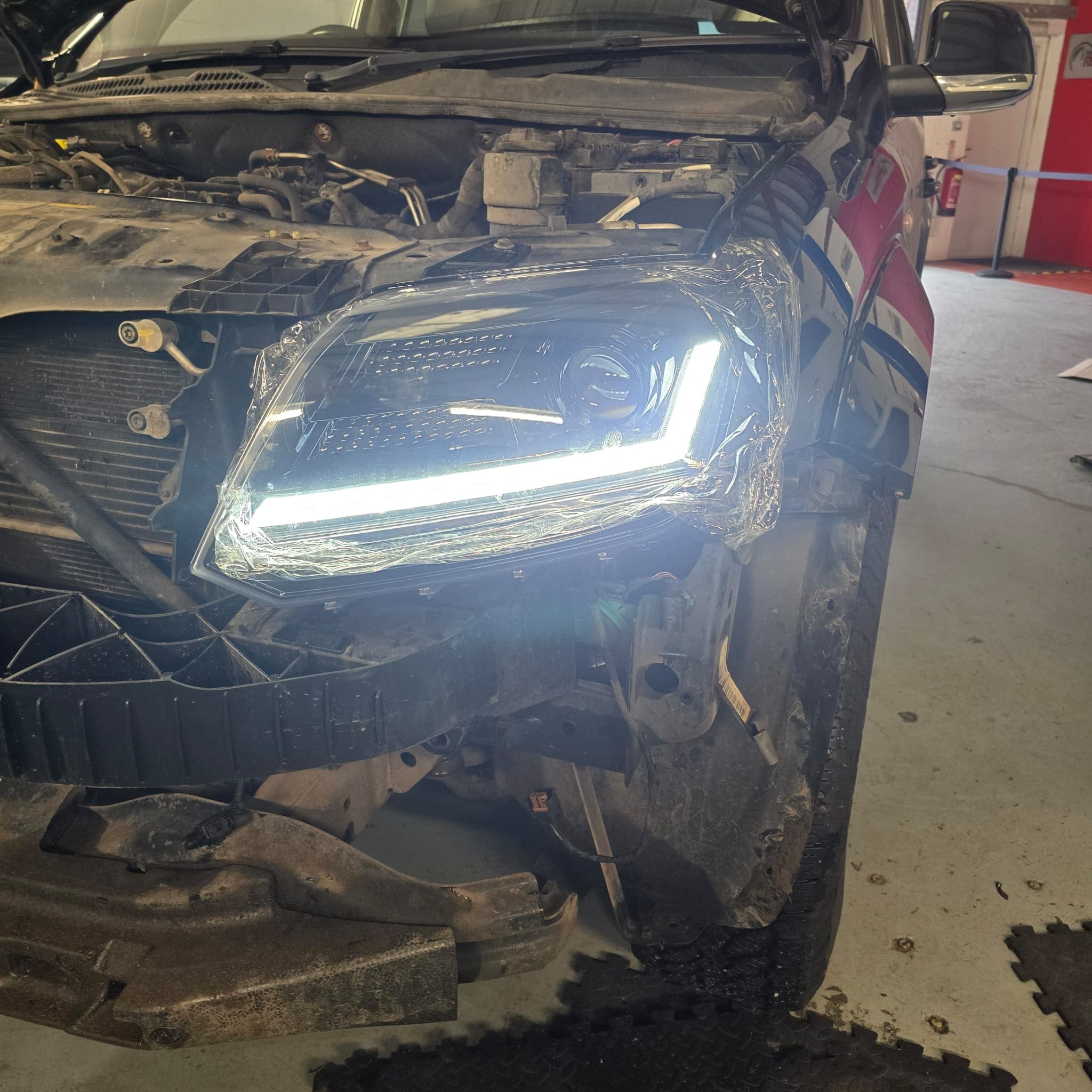 Detail shot of black OSRAM LED headlamp lens and housing on VW Amarok