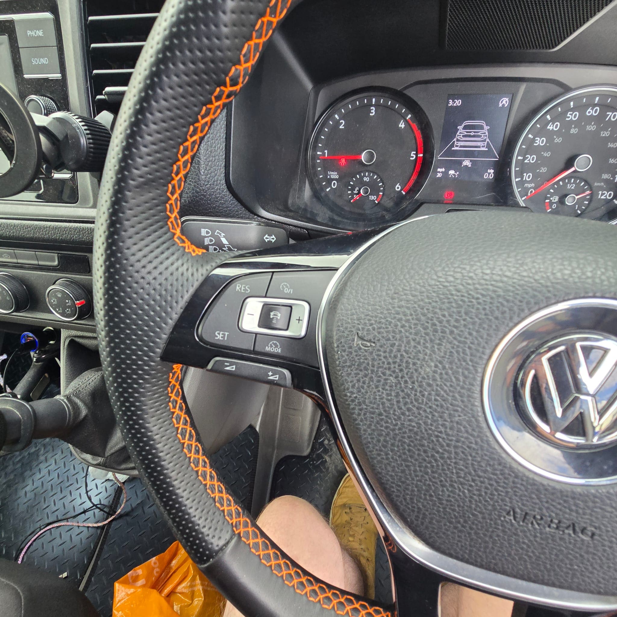 Close-up of retrimmed Volkswagen Crafter steering wheel with orange stitching and leather finish