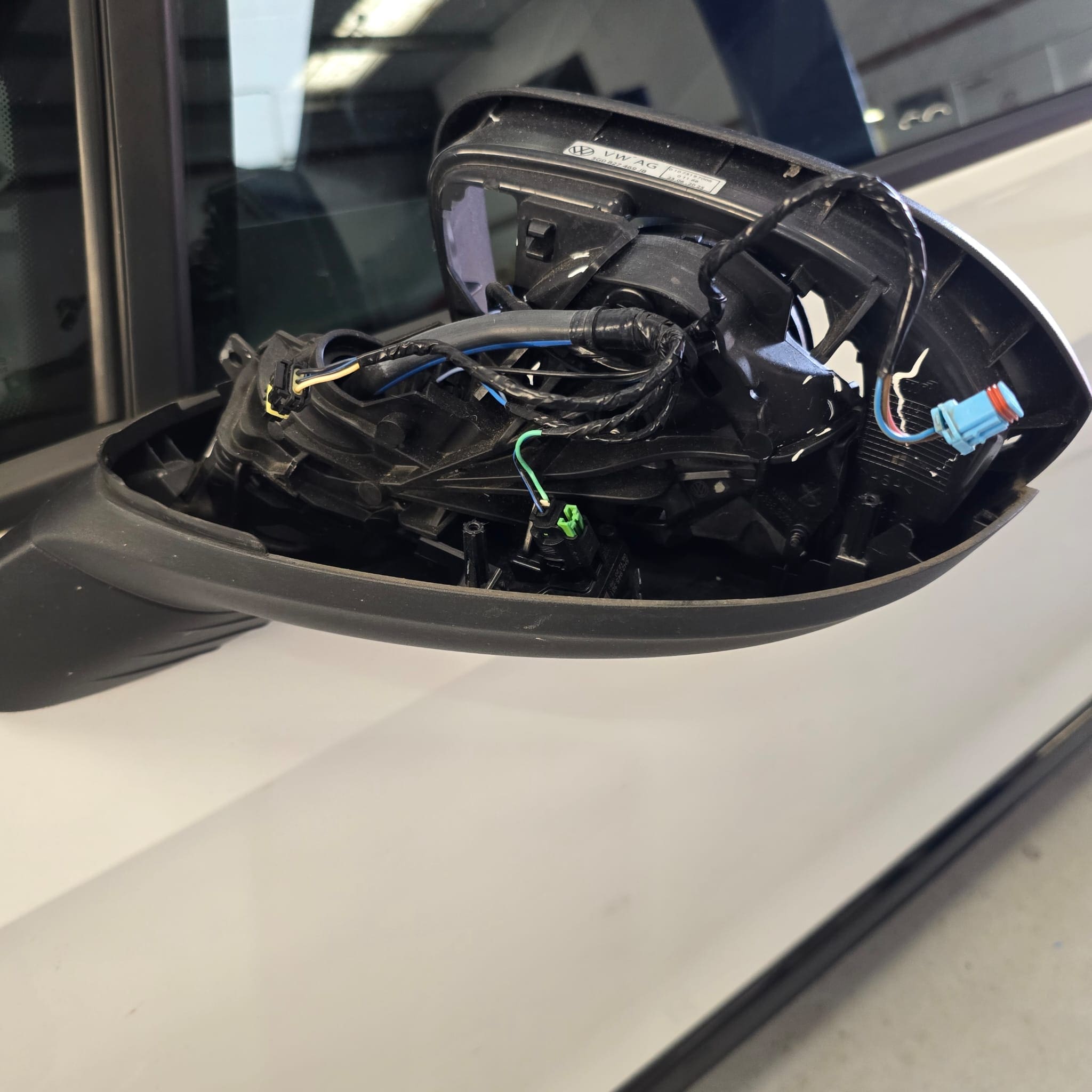 VW Golf Mk8 with sequential mirror indicators and GOLF writing fitted on a white and black car