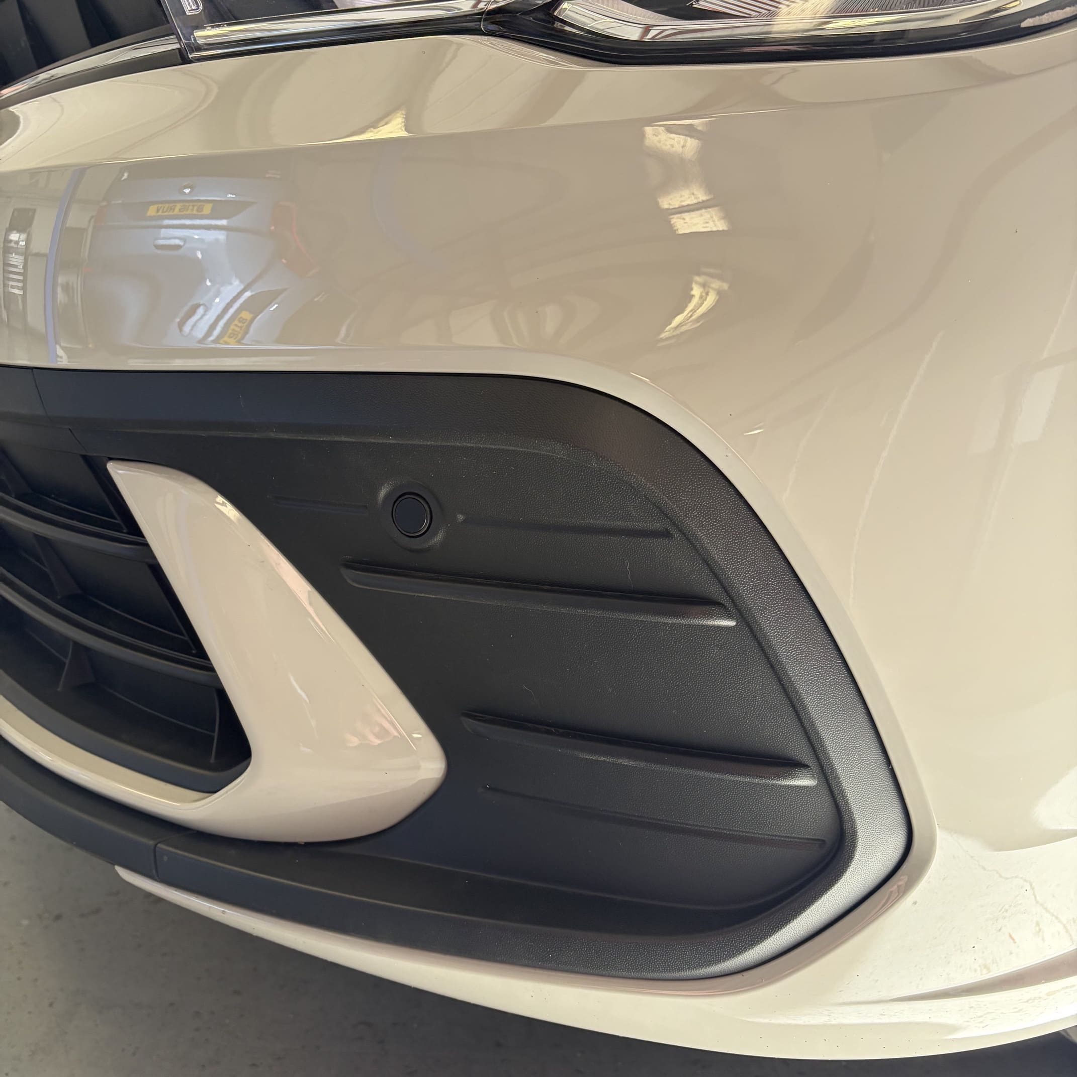Front parking sensor retrofit on VW Polo AW showing neat flush-fit finish