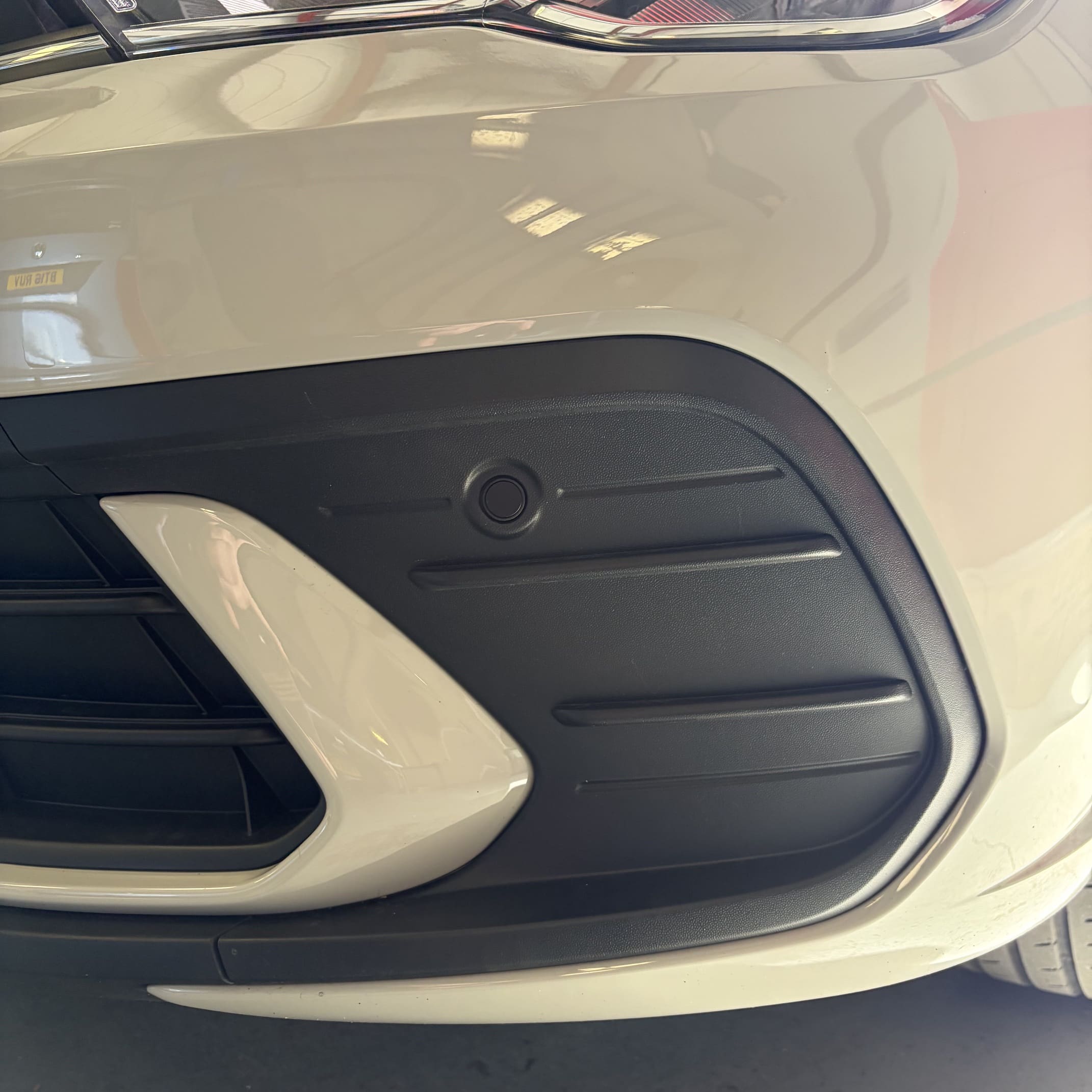 Close view of flush-fit front parking sensors on a VW Polo AW bumper