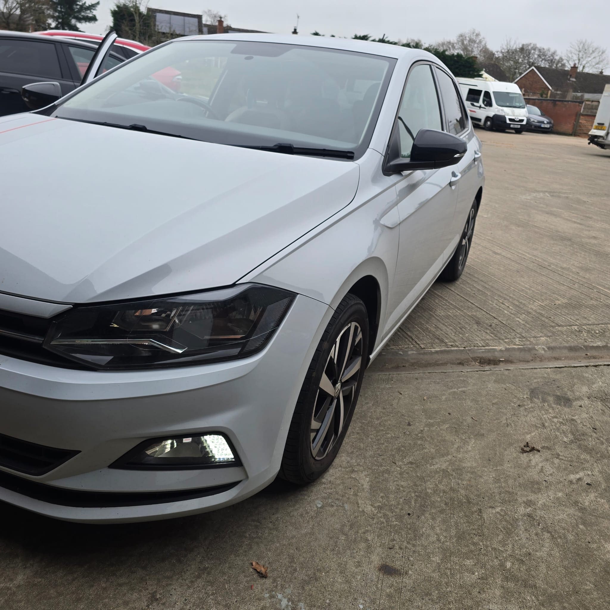 Finished rear parking sensor retrofit on VW Polo showing even sensor spacing and clean fitment