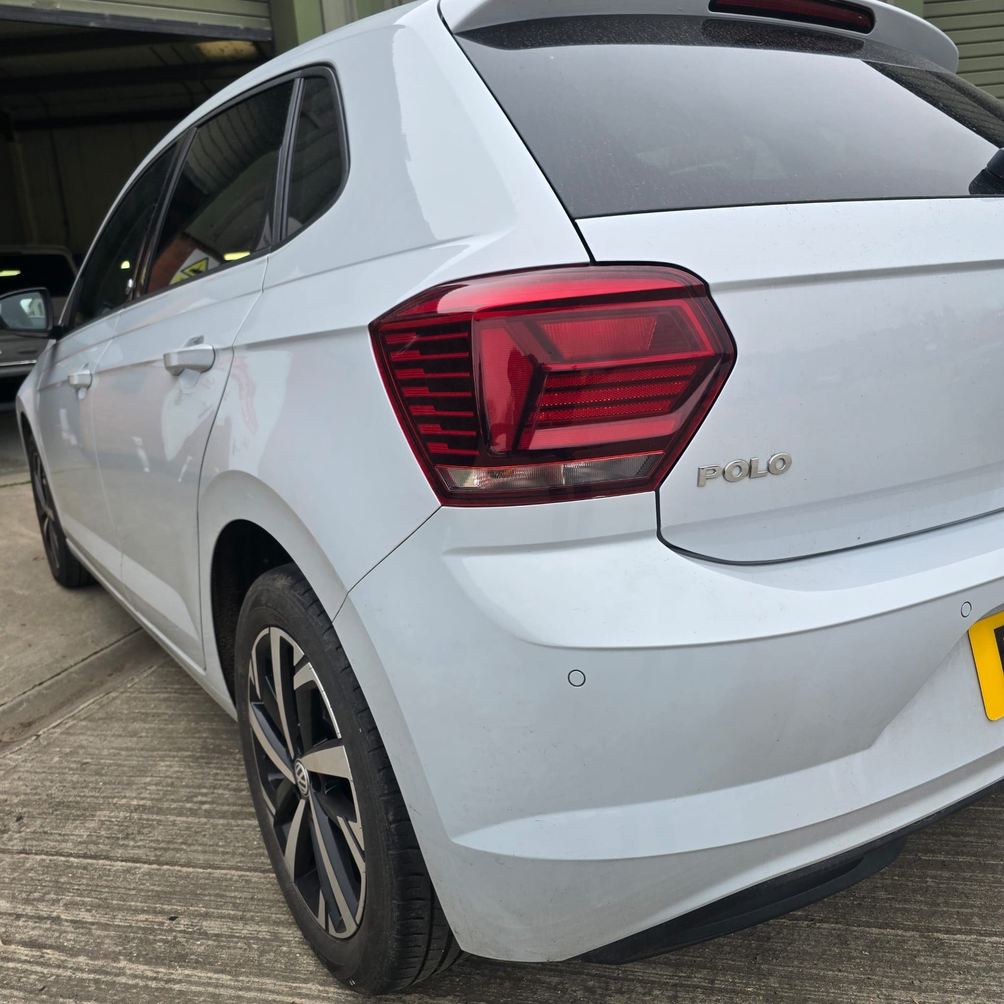 Close-up of Vodafone R394 sensor fitted flush in the VW Polo rear bumper with matching paint