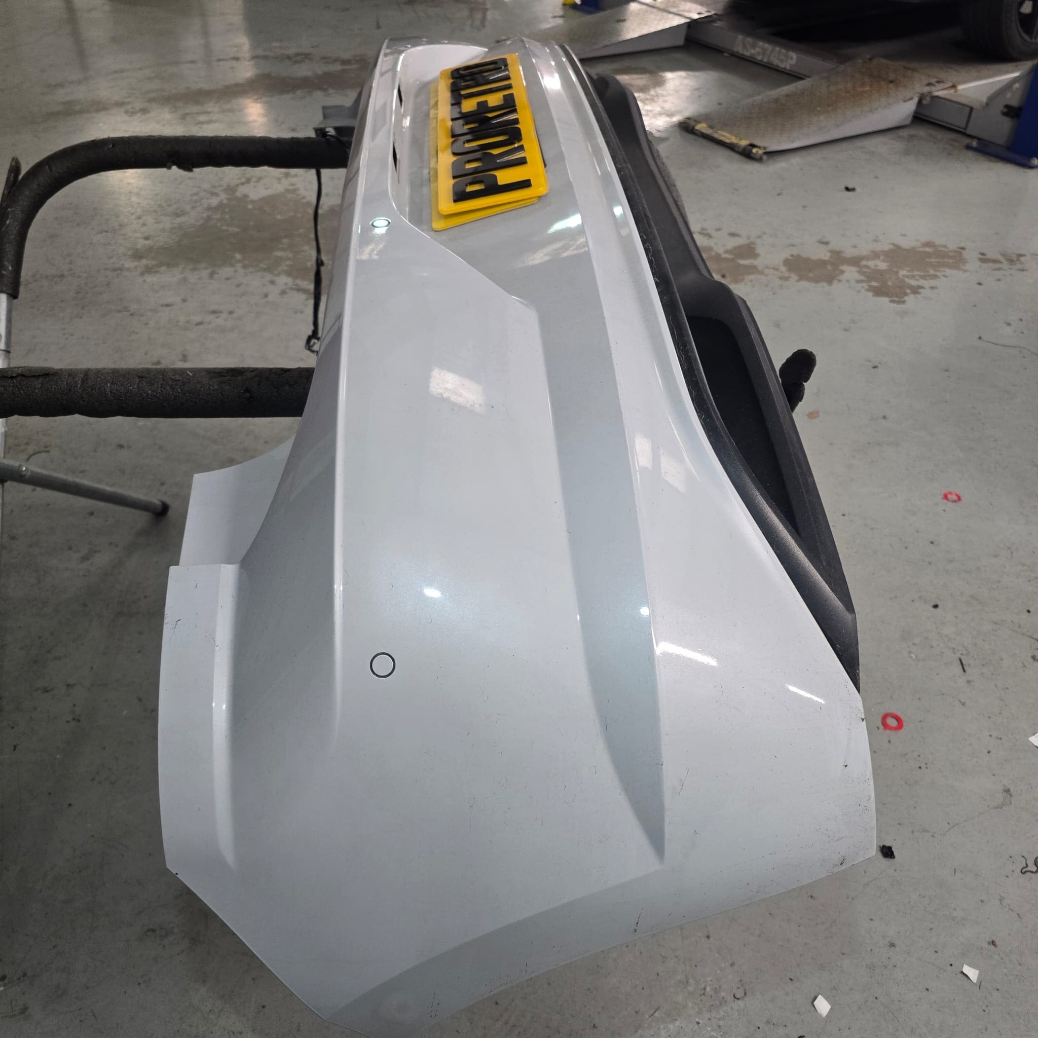 Rear bumper detail on VW Polo with factory-style color-matched flush sensors installed
