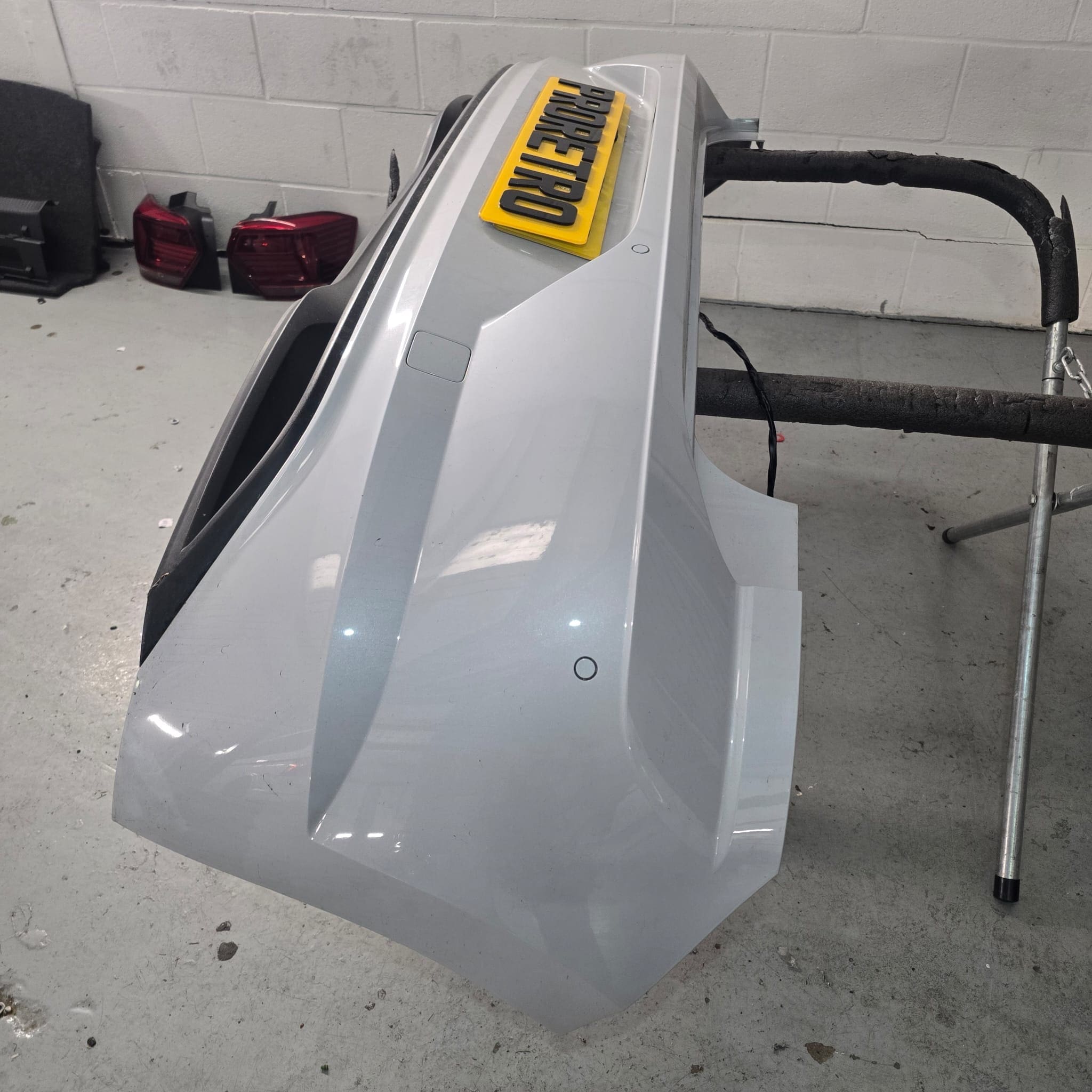 Side angle of VW Polo rear bumper showing discreet flush-fit sensor installation