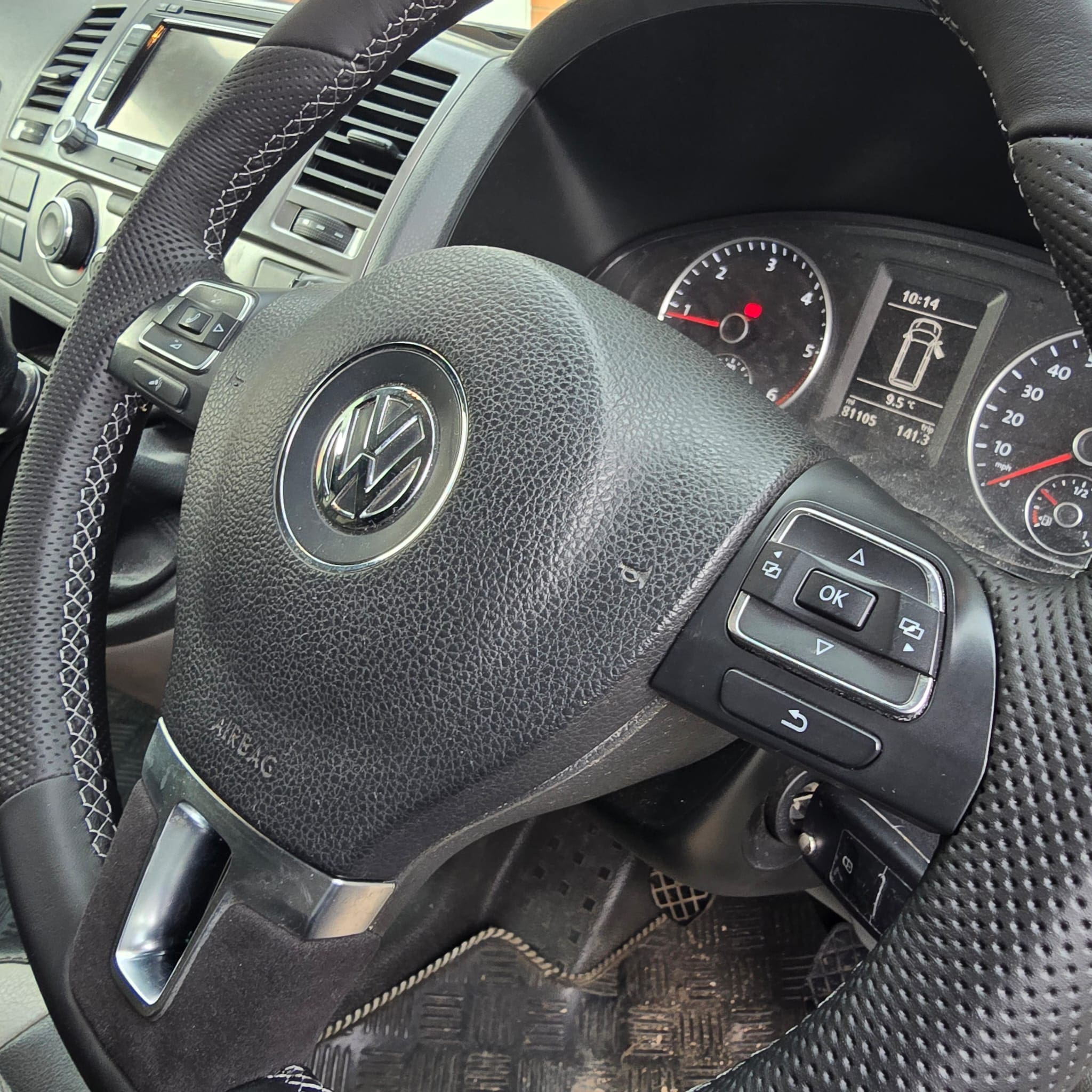Close-up of the perforated top section on a VW T5.1 steering wheel retrim with grey stitching detail