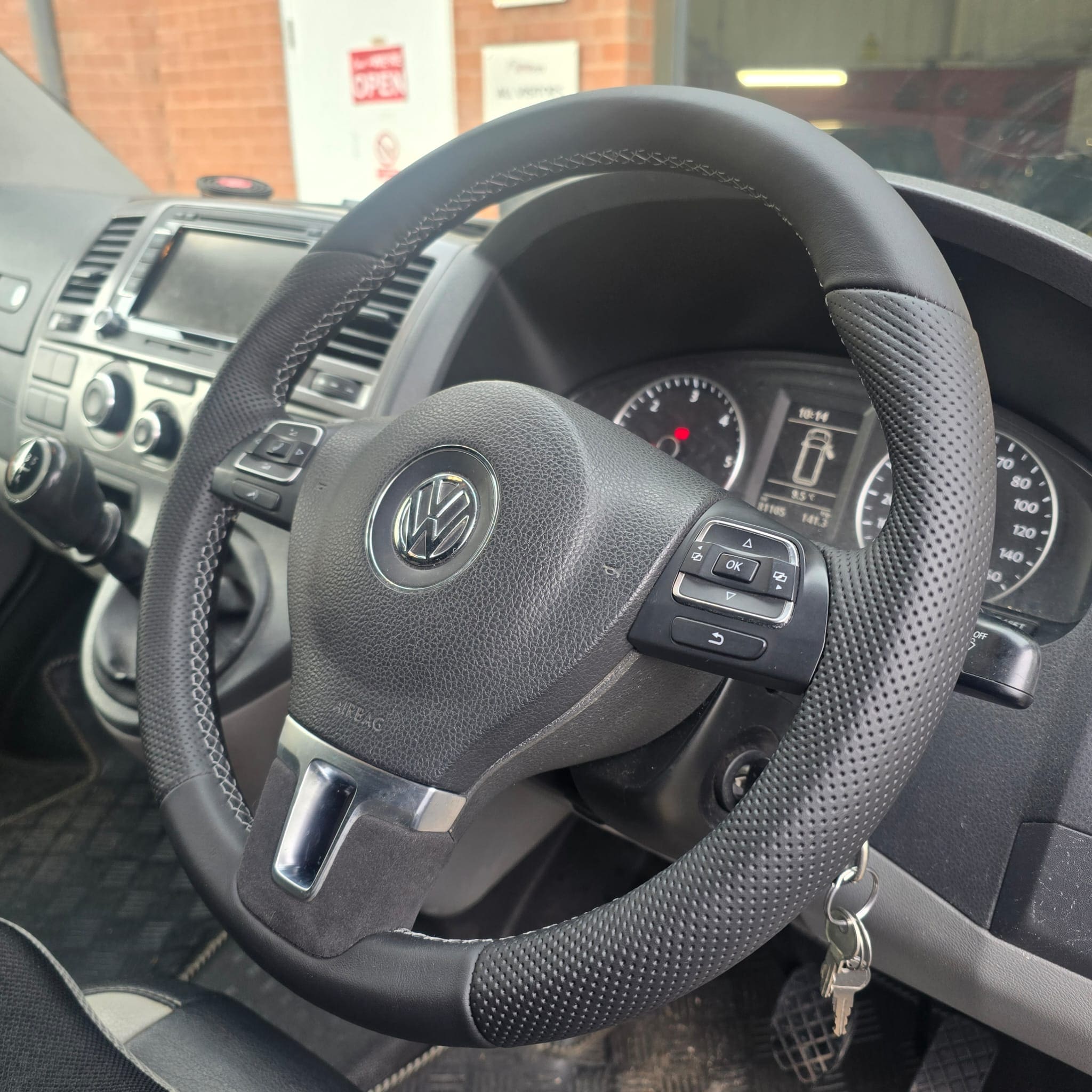 Driver view of VW T5.1 multifunction steering wheel retrim showing the overall OEM-style finish