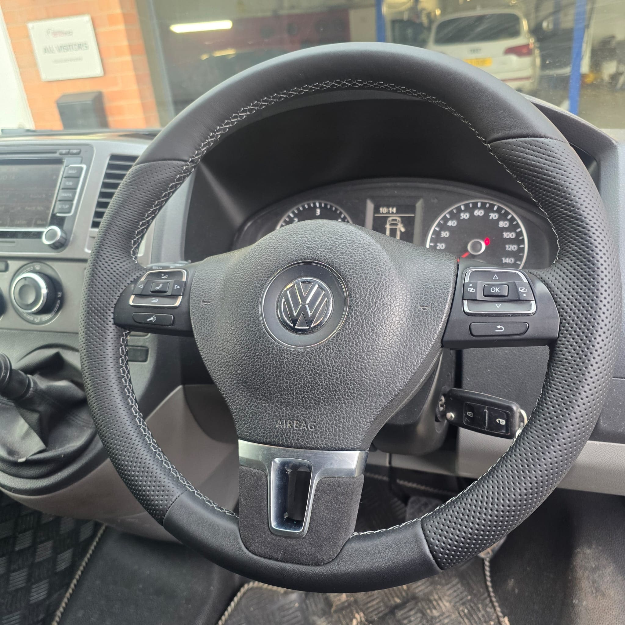 VW T5.1 multifunction steering wheel after retrim showing nappa leather, perforated top, grey stitching, and black Alcantara lower grip