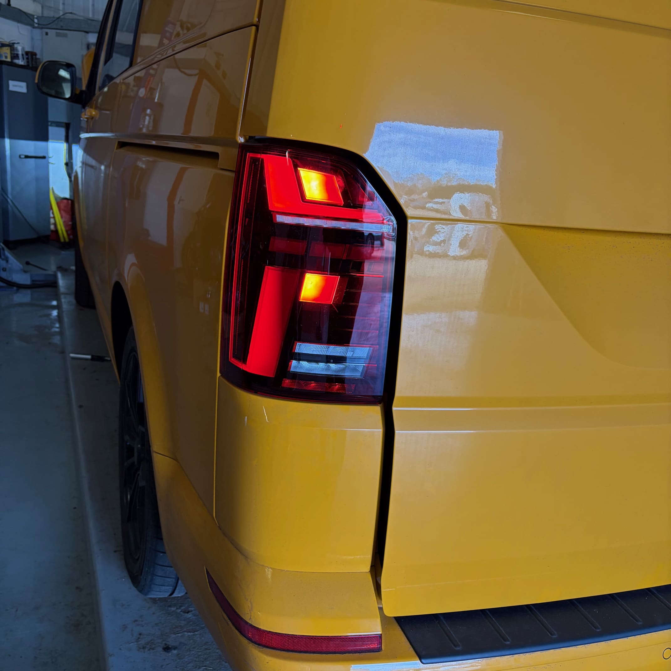 Rear corner view of a VW T6.1 showing the genuine smoked LED taillight fitted and aligned