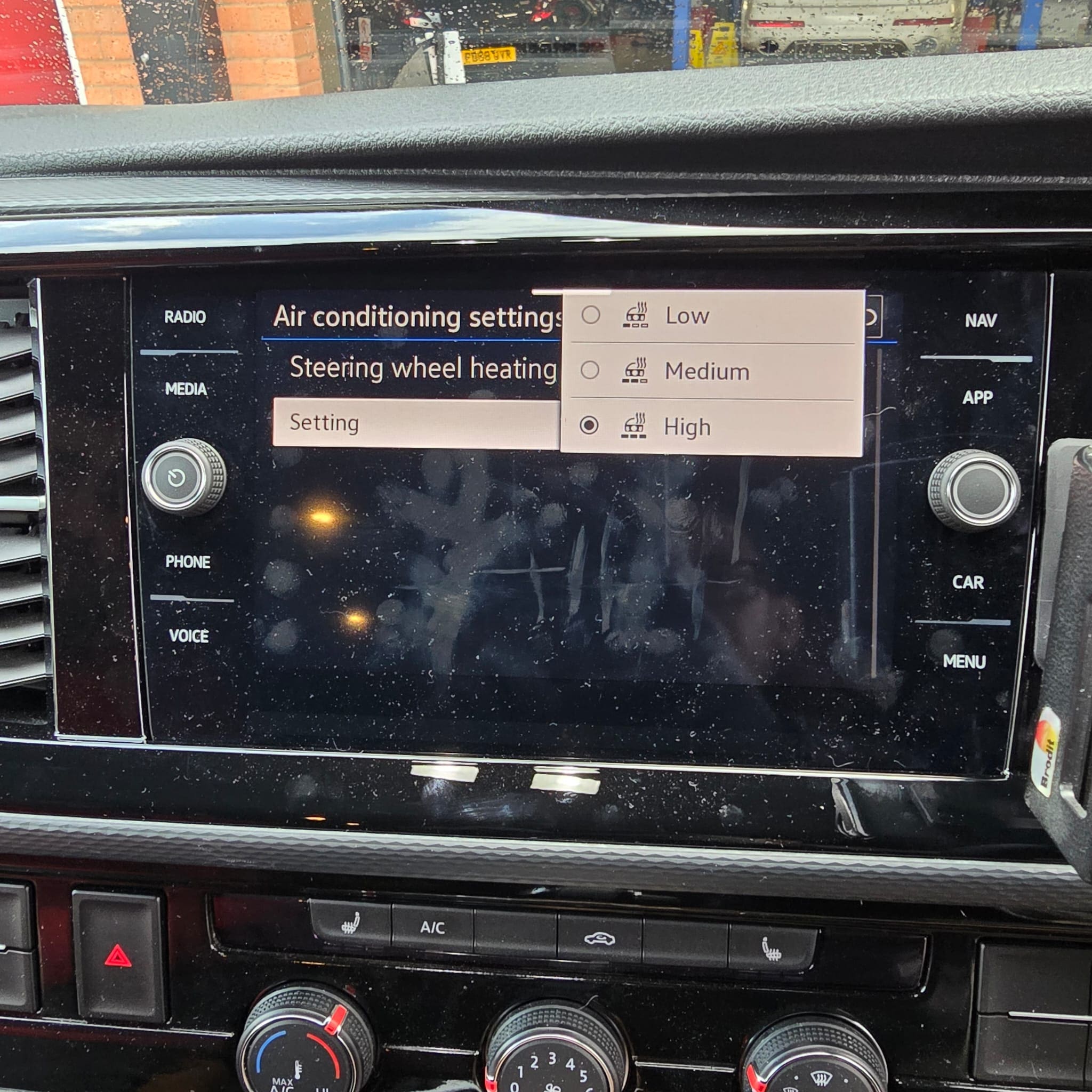 Close-up of heated steering wheel button on VW T6.1 steering wheel after retrofit