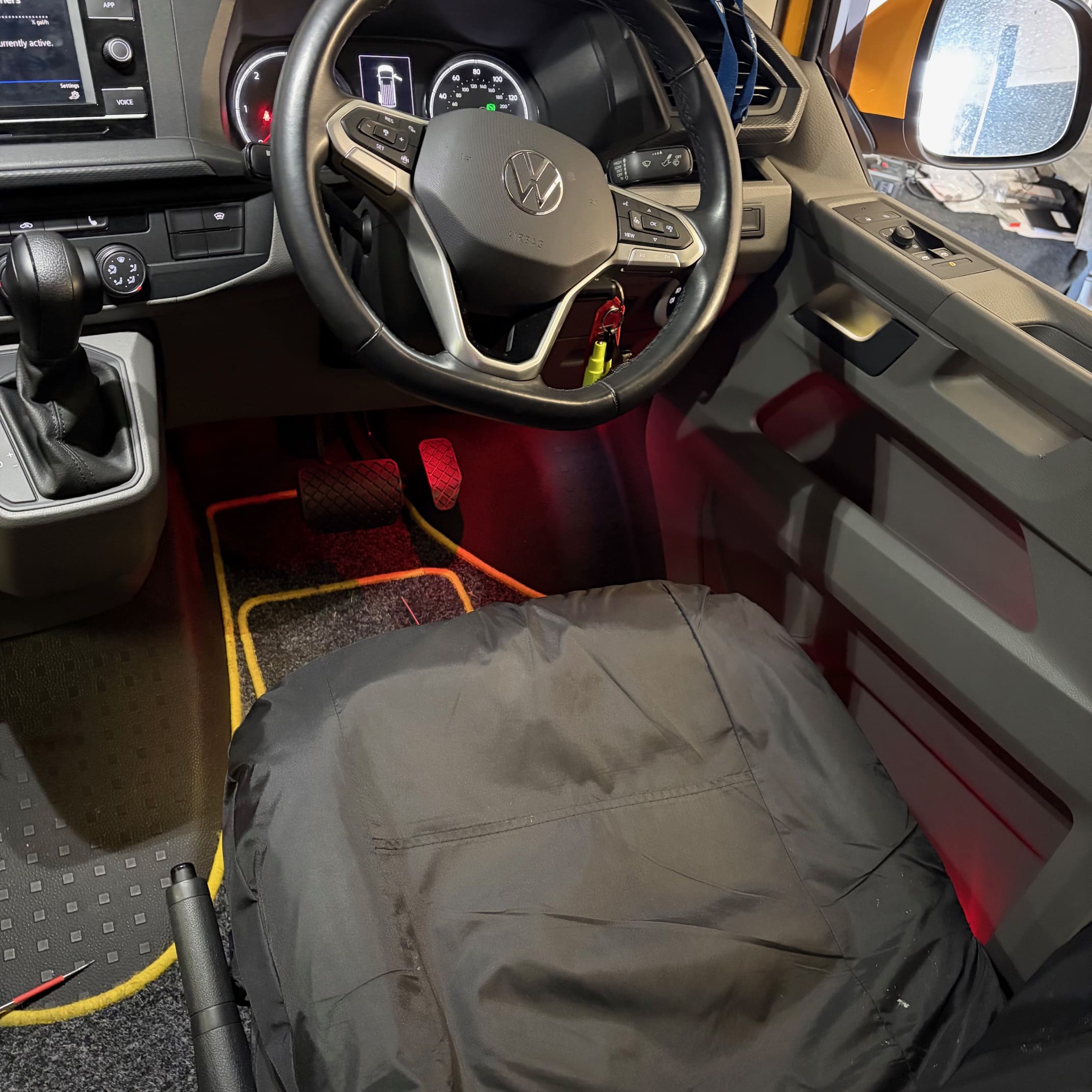VW Transporter ambient lighting retrofit completed with red door and footwell illumination