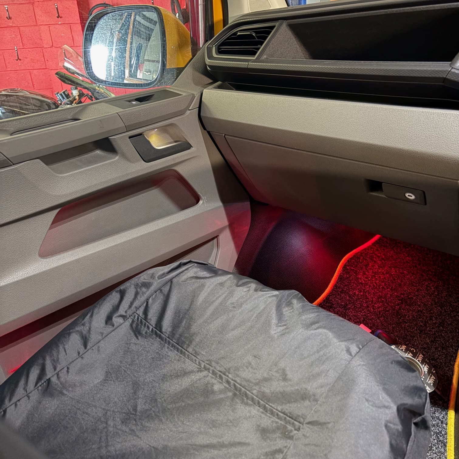 Close-up of VW Transporter door area after fitting white handle light and red ambient lighting
