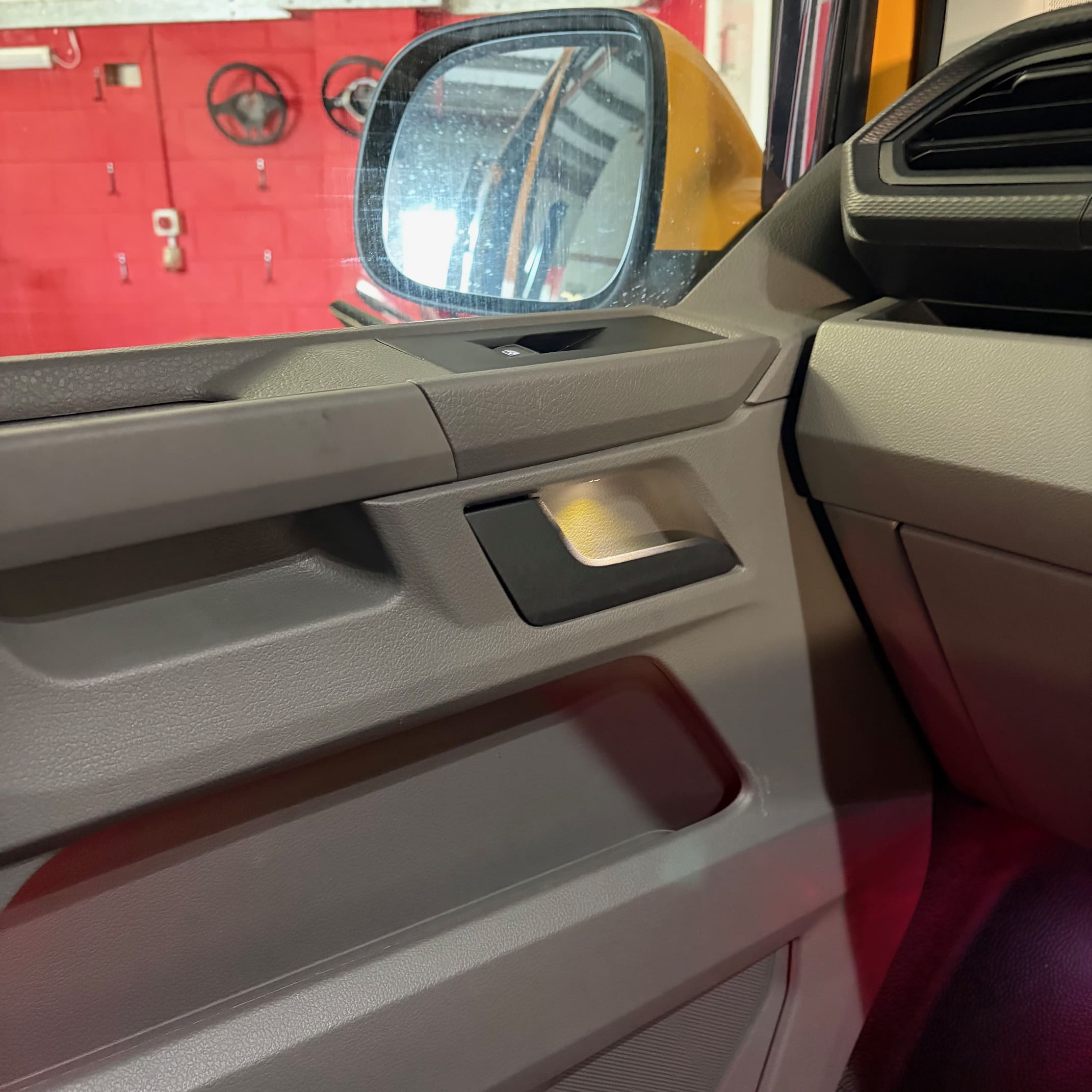 White door handle illumination installed on a VW Transporter showing courtesy-light style operation