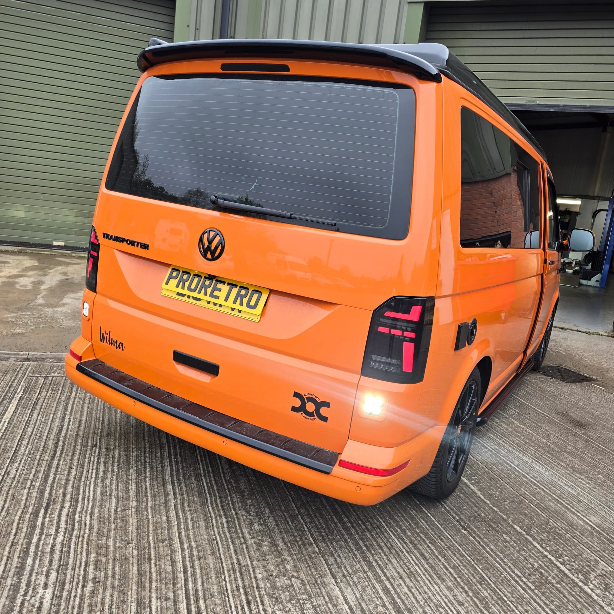 Angle view of VW Transporter rear bumper trim with color-matched reverse light pod