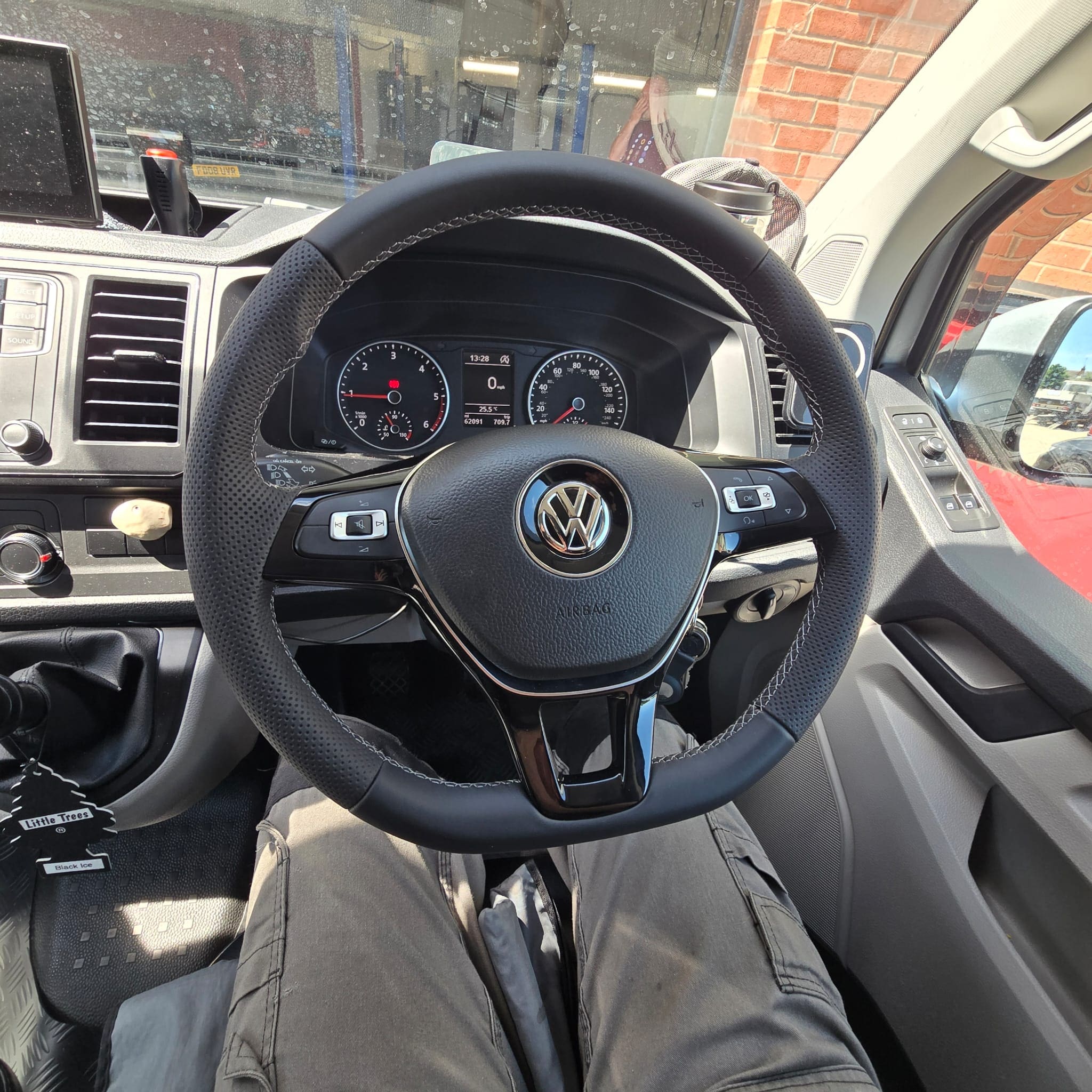 Close view of multifunction steering wheel controls in a VW Transporter